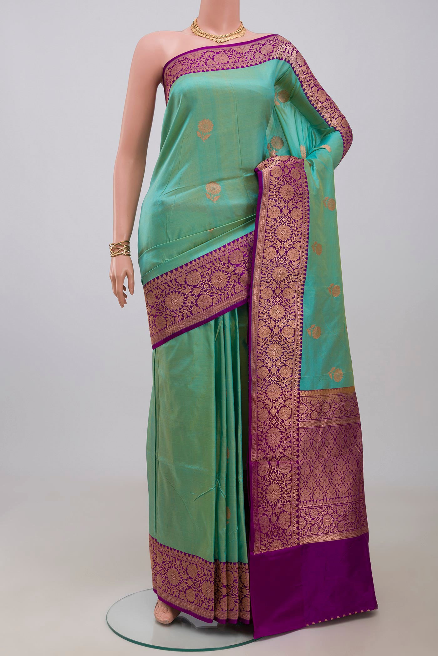Sky Blue Banarasi Katan Silk Saree with Zari Butta on the body and Fancy Border.  displayed on a mannequin