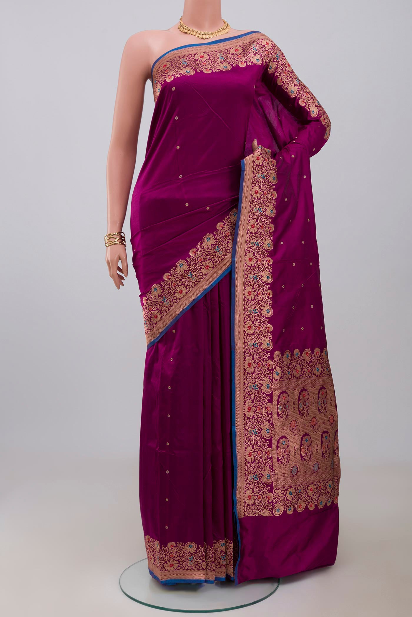 Purple Banarasi Katan Silk Saree with Zari Butta on the body and Fancy Border.  displayed on a mannequin