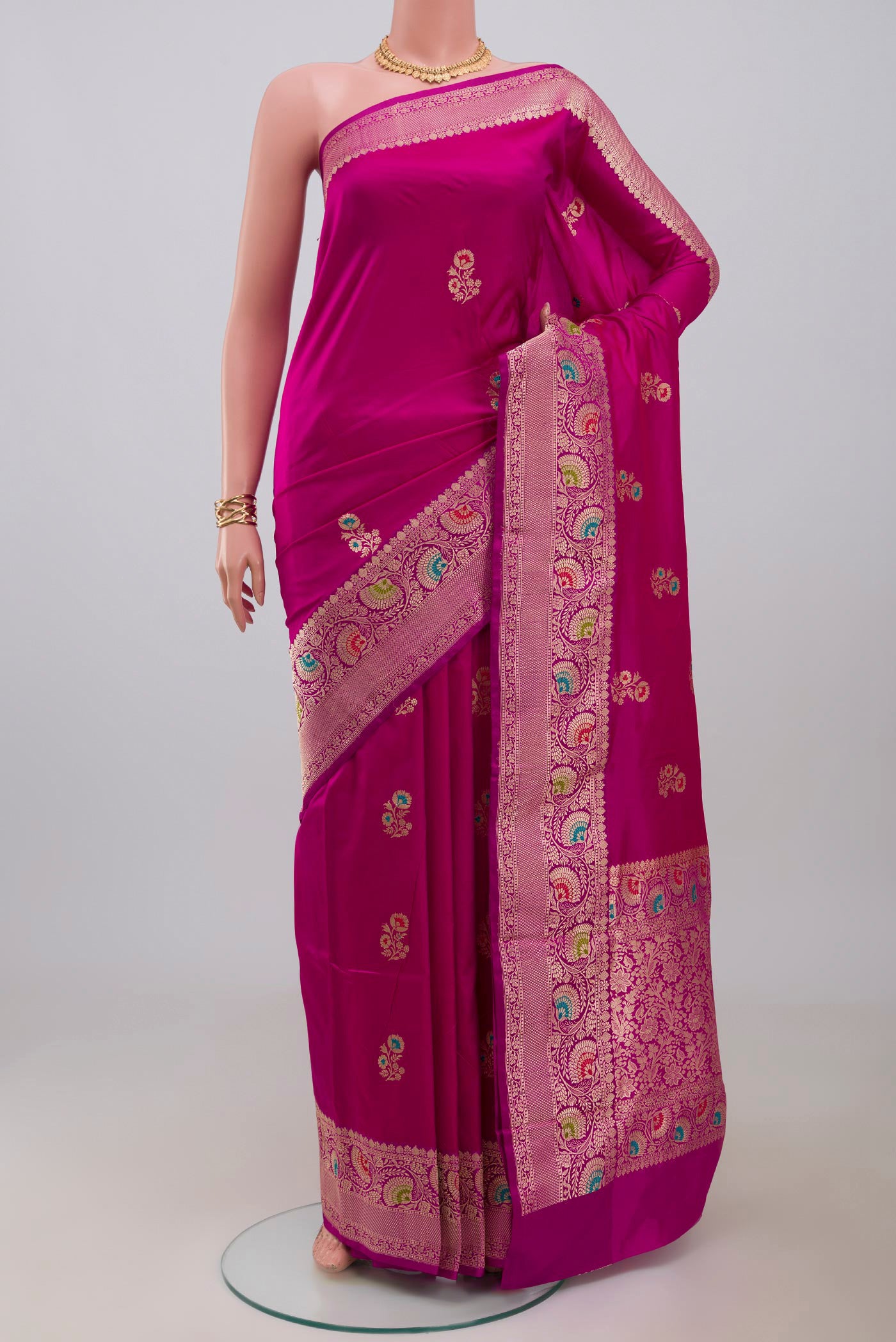 Pink Banarasi Katan Silk Saree with Zari Butta on the body and Fancy Border.  displayed on a mannequin