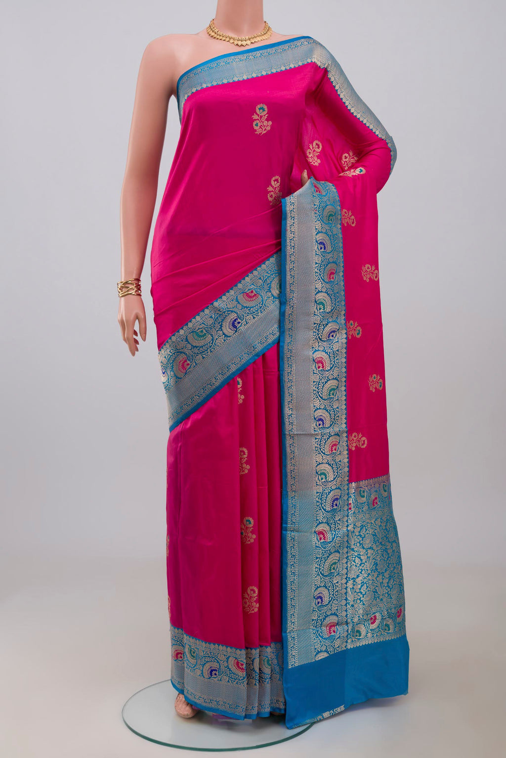 Pink Banarasi Katan Silk Saree with Zari Butta on the body and Fancy Border.  displayed on a mannequin