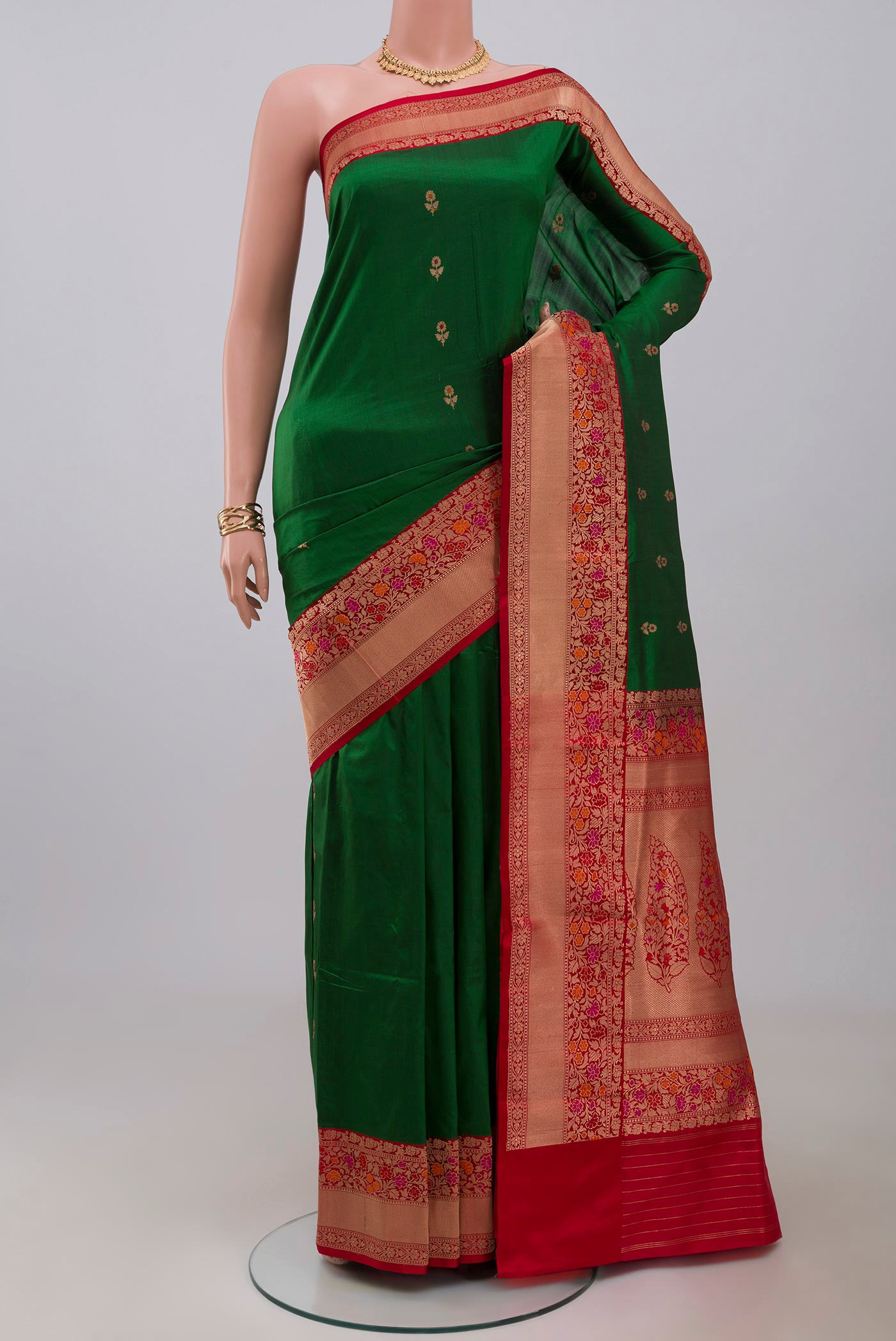 Green Banarasi Katan Silk Saree with Zari Butta on the body and Zari Border.  displayed on a mannequin