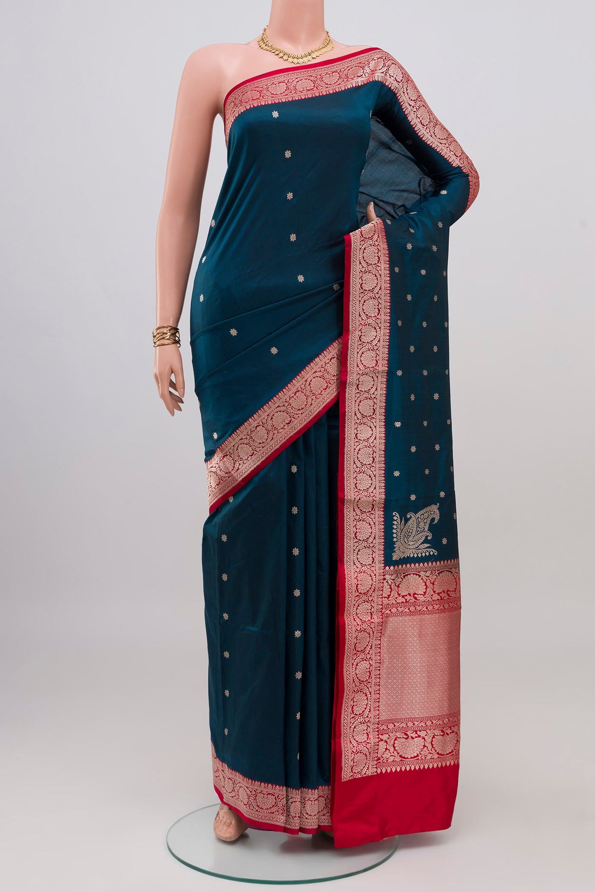 Blue Banarasi Katan Silk Saree with Zari Butta on the body and Zari Border.  displayed on a mannequin