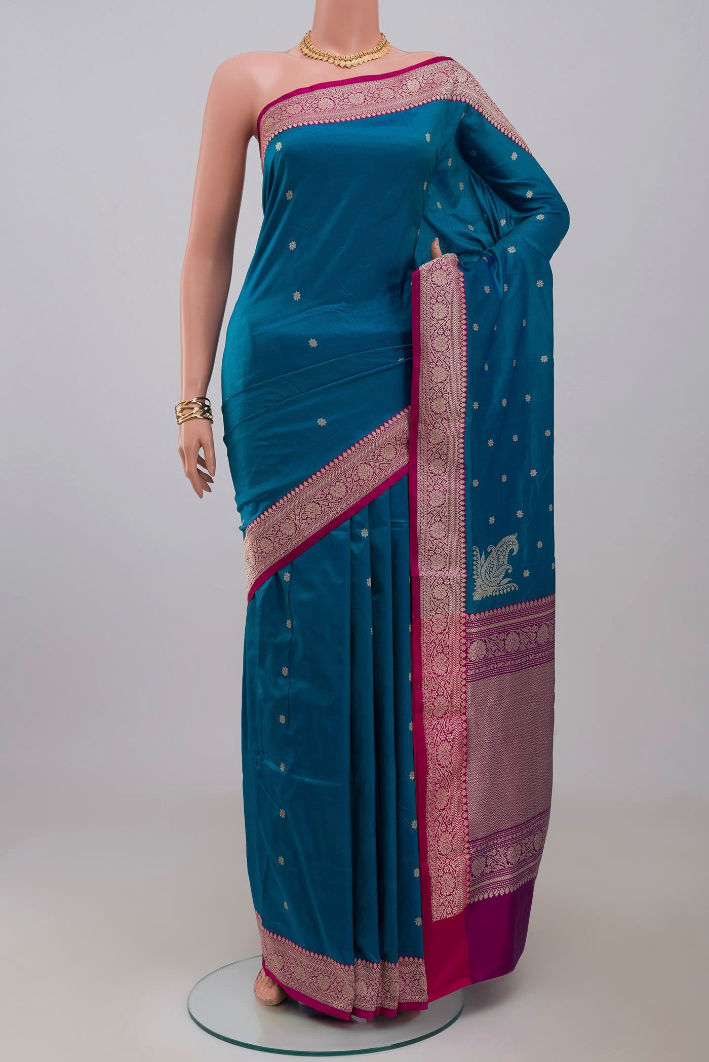 Blue Banarasi Katan Silk Saree with Zari Butta on the body and Fancy Border.  displayed on a mannequin