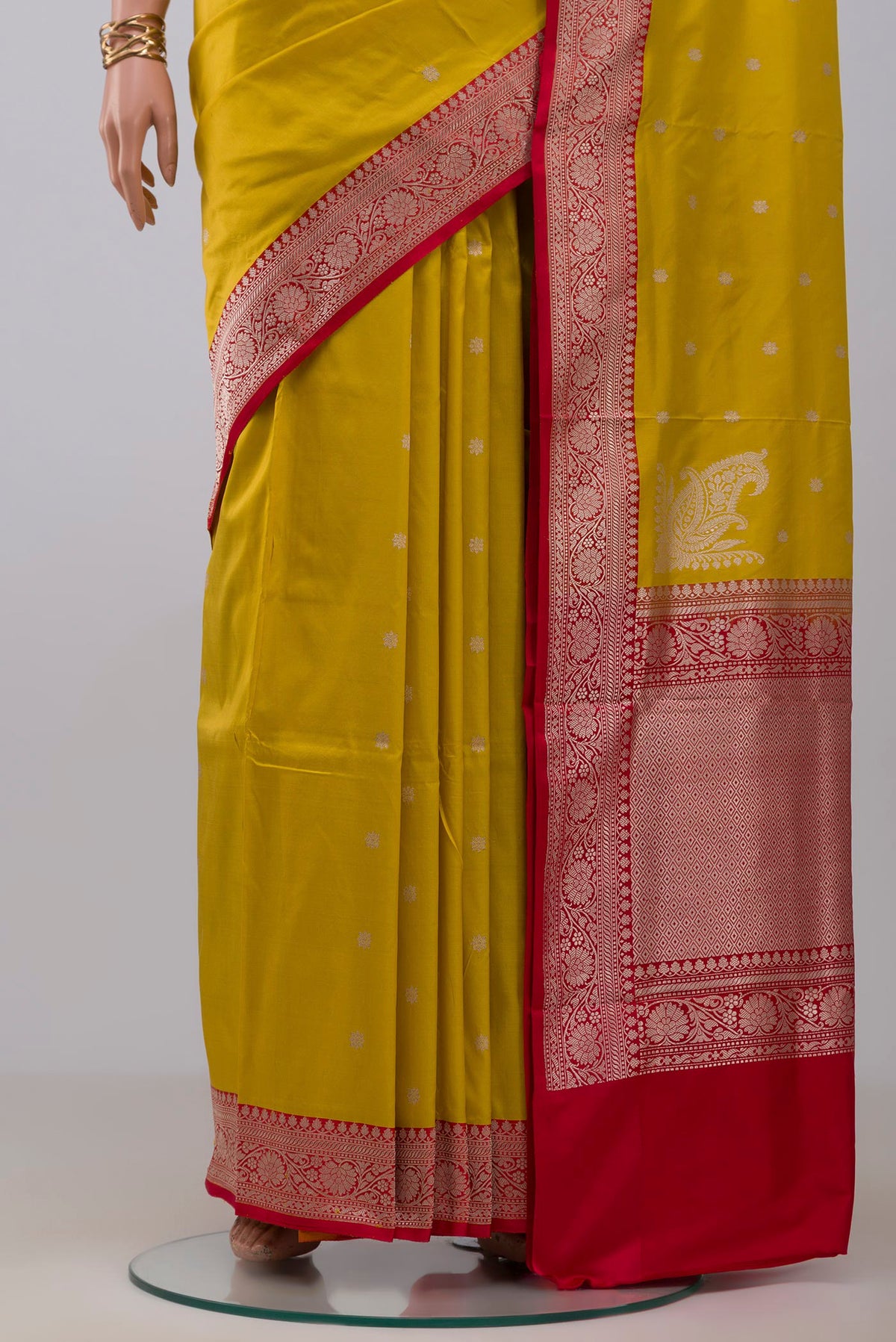 Pleats and pallu of Yellow Banarasi Katan Silk Saree with Zari Butta on the body and Zari Border. 