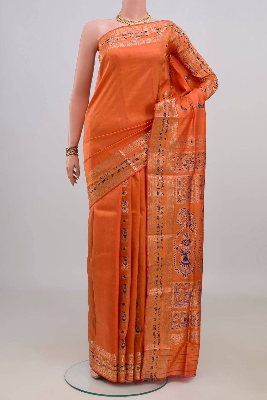Pure Silk Orange Baluchari Saree with Zari Butta on the body and Fancy Border.  displayed on a mannequin