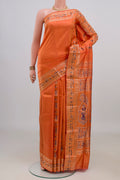 Pure Silk Orange Baluchari Saree with Zari Butta on the body and Fancy Border.  displayed on a mannequin