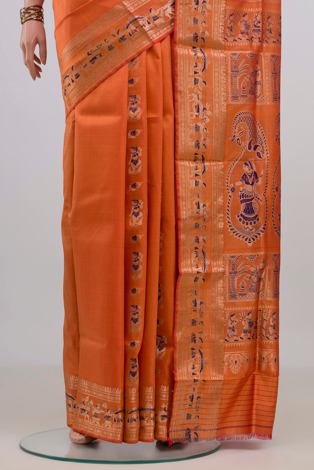 Pleats and pallu of Pure Silk Orange Baluchari Saree with Zari Butta on the body and Fancy Border. 