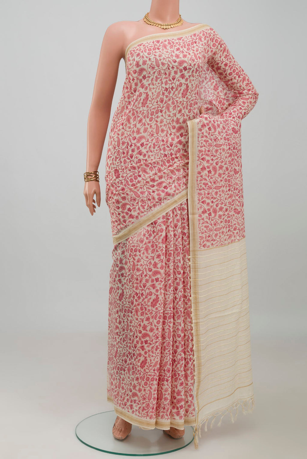 Cream Tussar Silk Saree with Printed design on the body and Thin Zari Line.  displayed on a mannequin