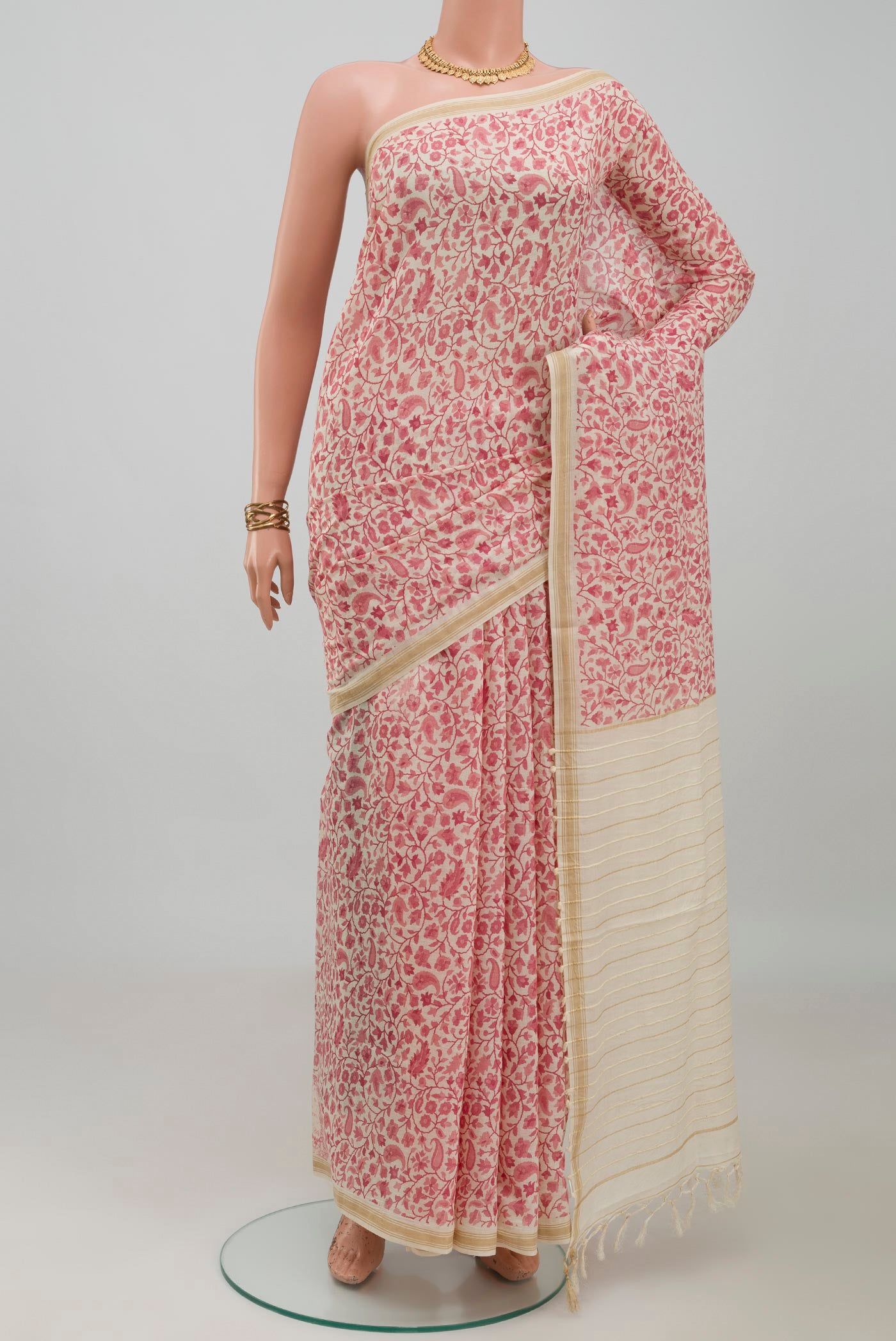 Cream Tussar Silk Saree with Printed design on the body and Thin Zari Line.  displayed on a mannequin