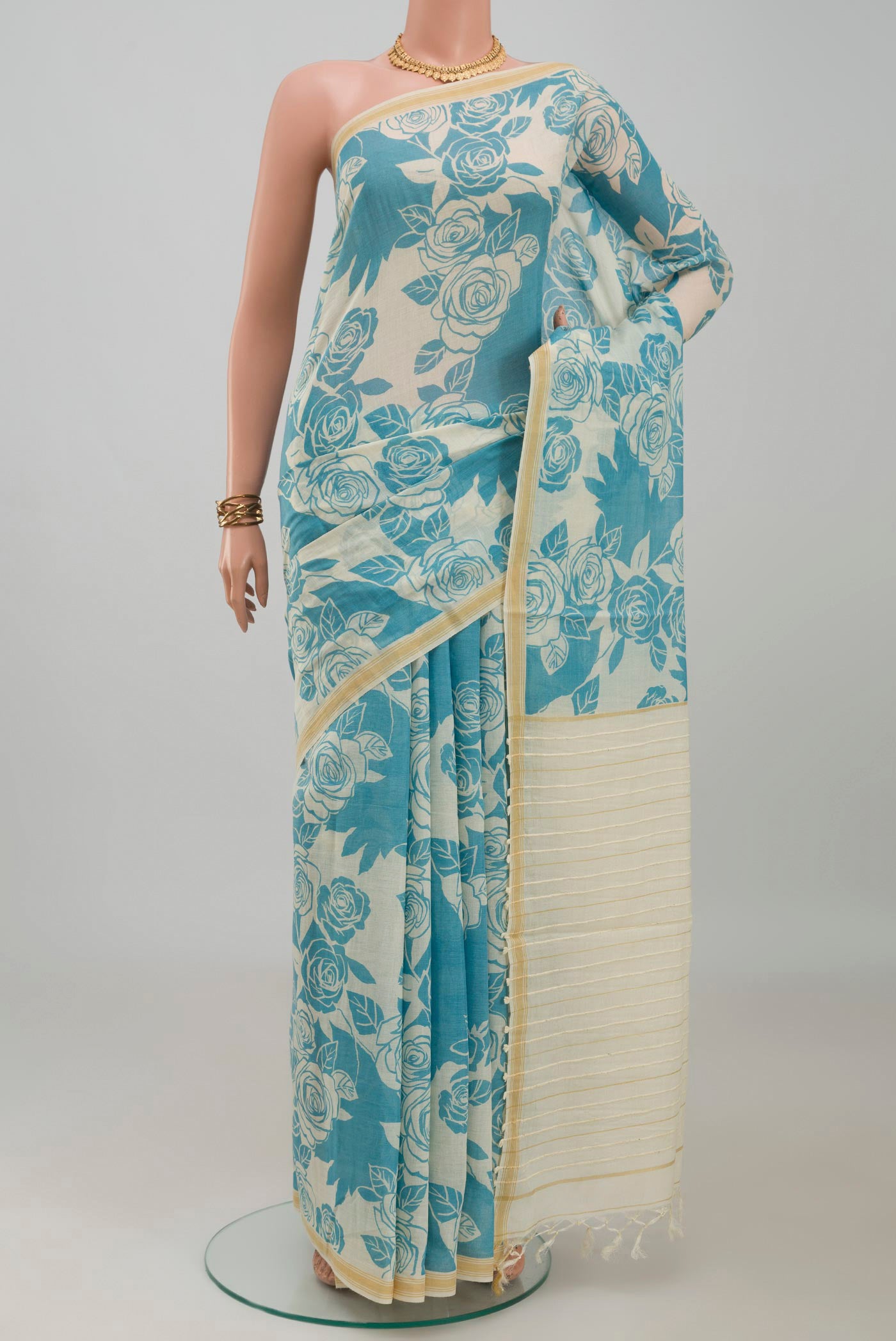 Cream Tussar Silk Saree with Floral Print on the body and Plain Border.  displayed on a mannequin