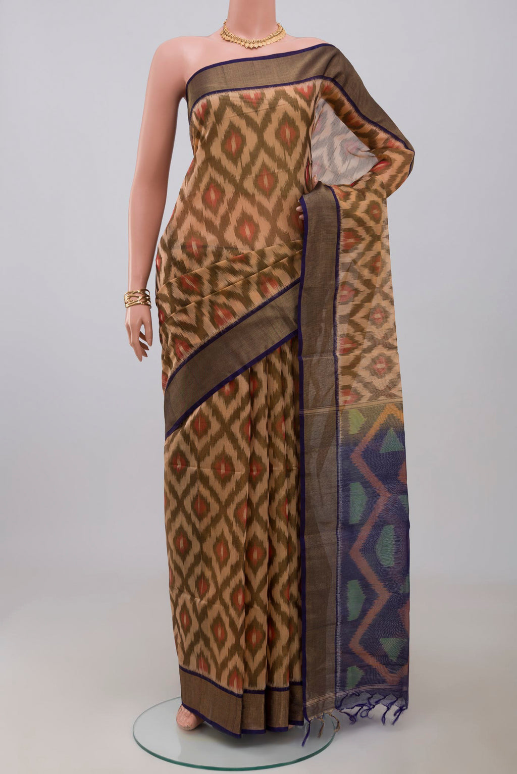 Cream Silk Cotton Saree with Ikat Print on the body and Zari Border.  displayed on a mannequin