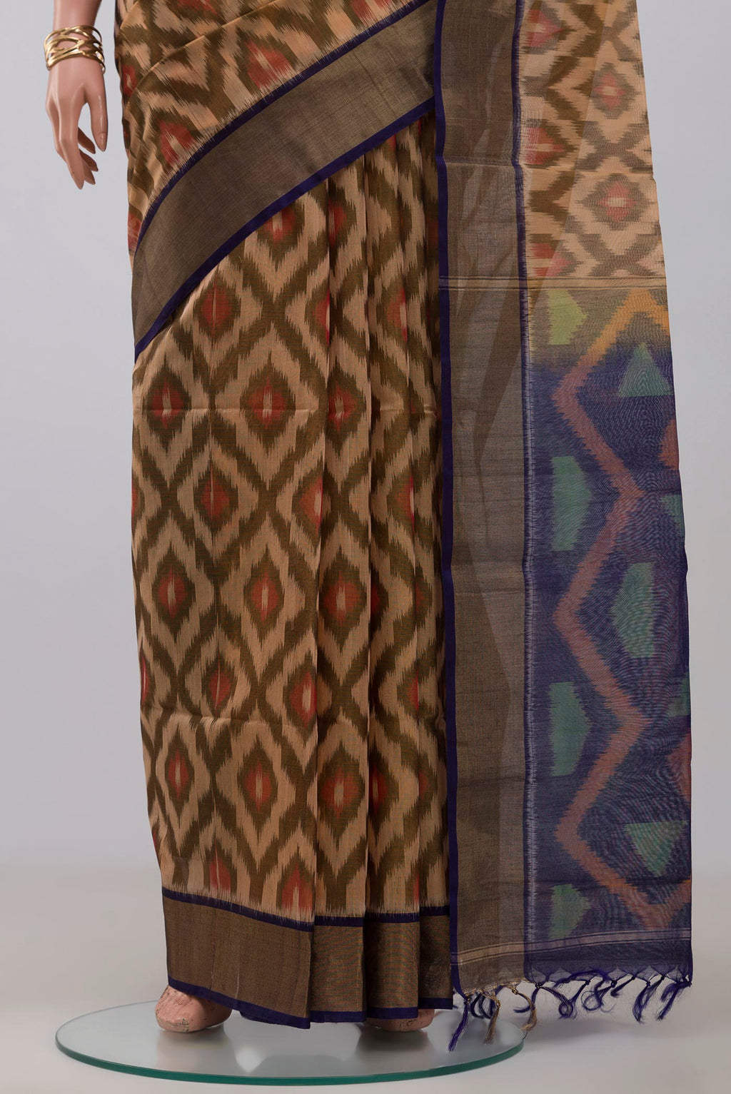 Pleats and pallu of Cream Silk Cotton Saree with Ikat Print on the body and Zari Border. 
