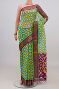 Light Green Silk Cotton Saree with Ikat design on the body and Zari Border.  displayed on a mannequin