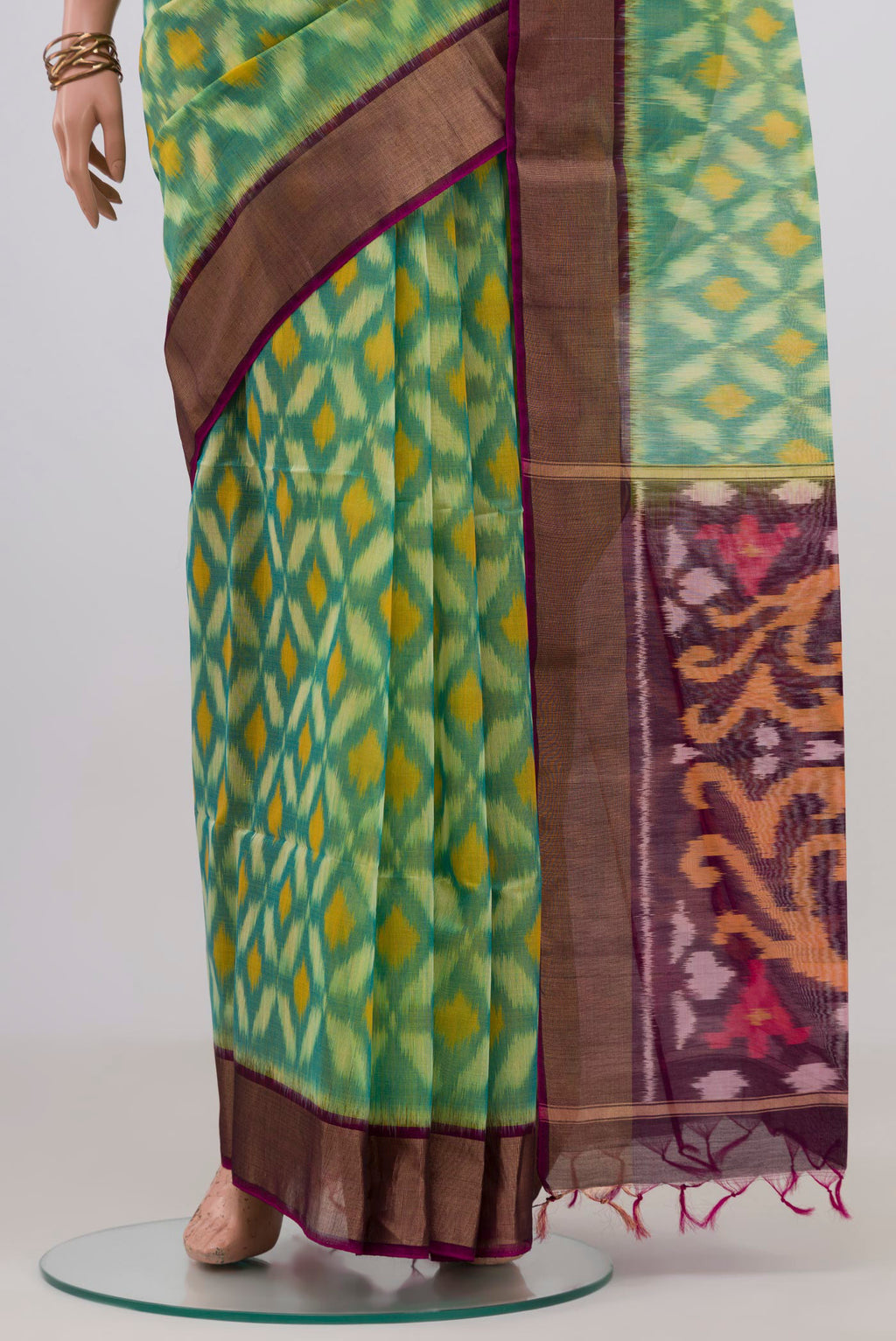 Pleats and pallu of Light Green Silk Cotton Saree with Ikat design on the body and Zari Border. 