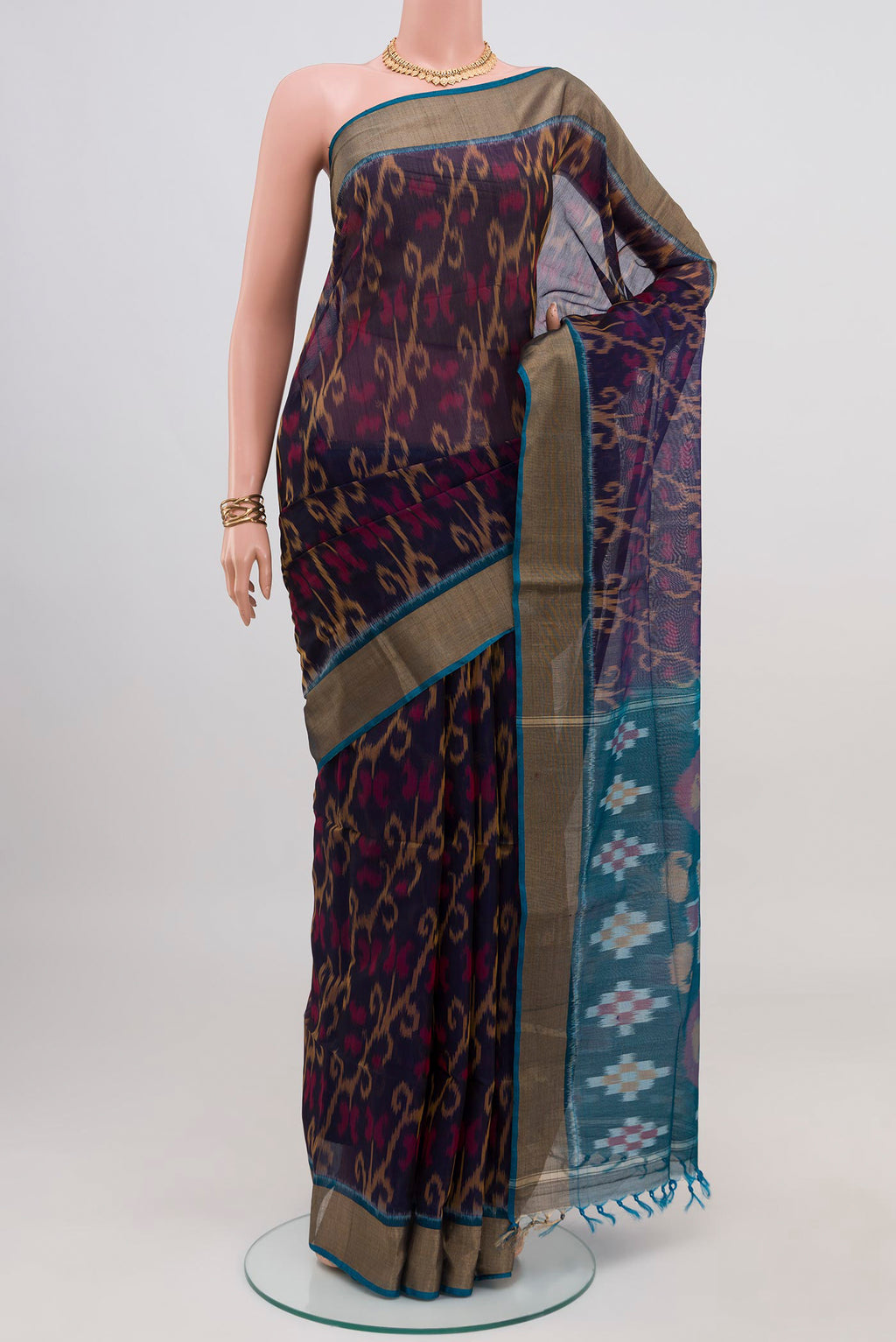 Navy Blue Silk Cotton Saree with Ikat design on the body and Zari Border.  displayed on a mannequin
