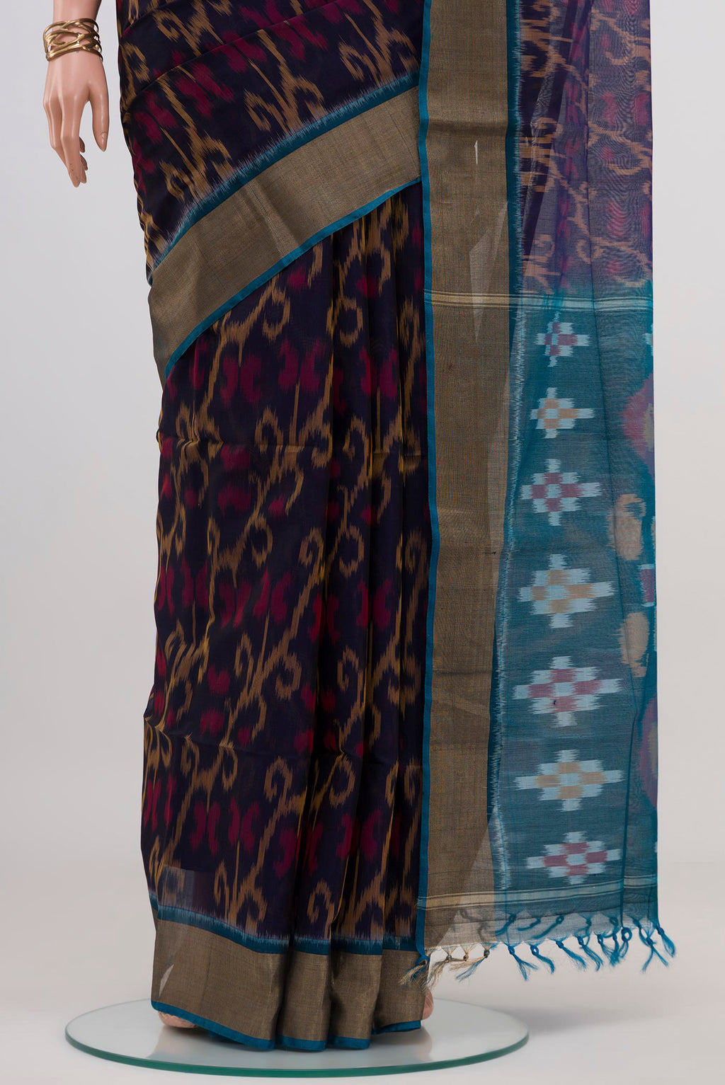 Pleats and pallu of Navy Blue Silk Cotton Saree with Ikat design on the body and Zari Border. 