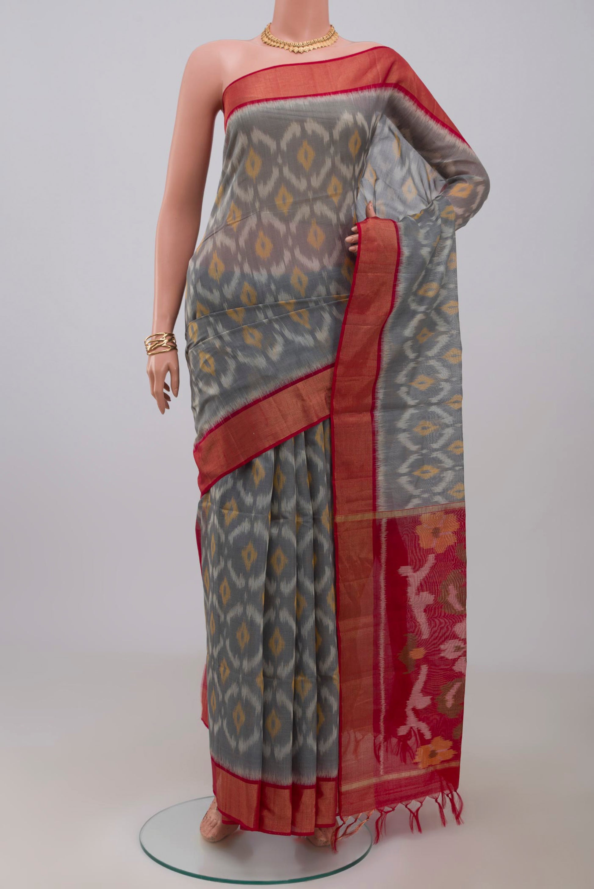 Grey Coimbatore Silk Cotton Saree with Ikat design on the body and Zari Border.  displayed on a mannequin