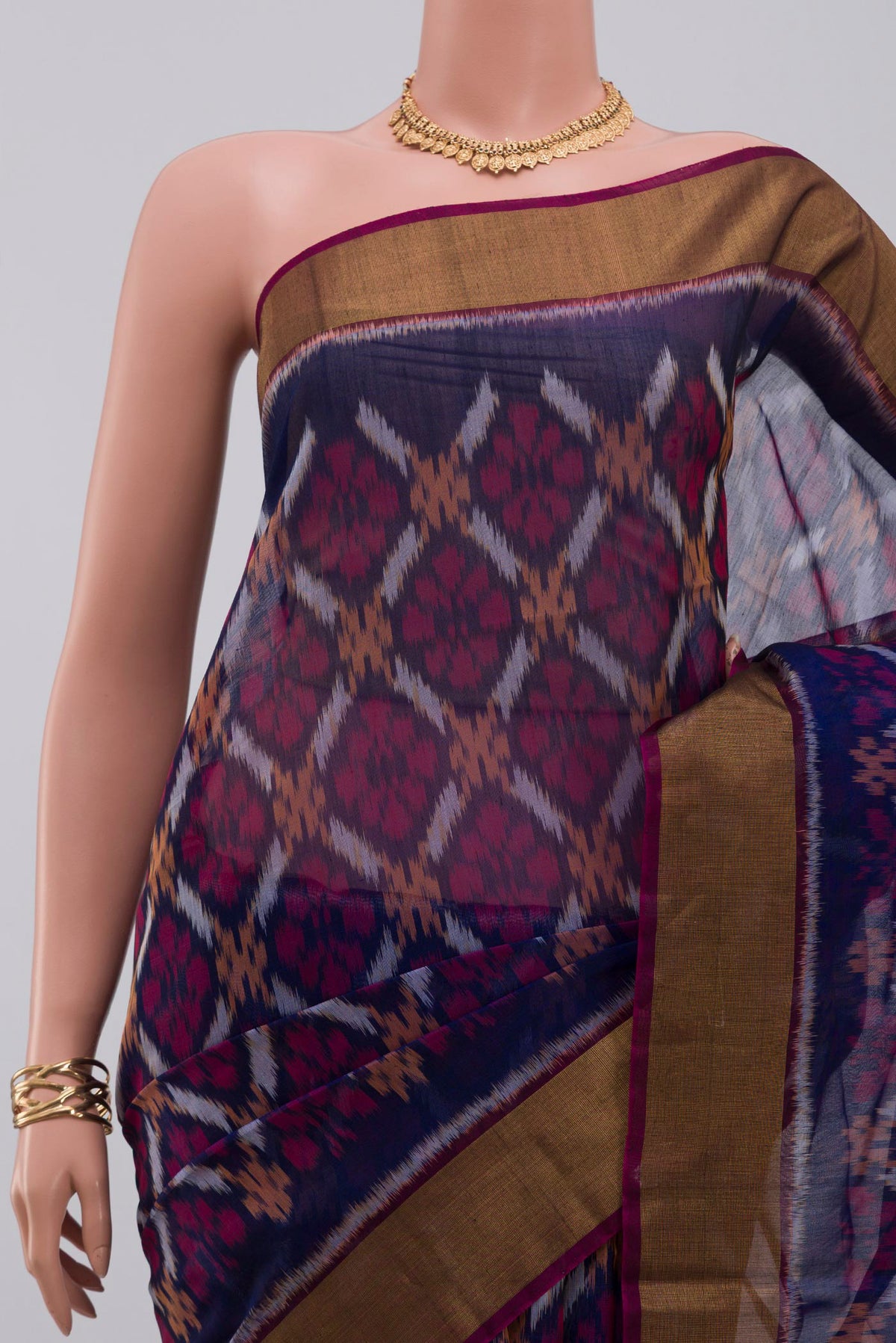 Border image of Blue Silk Cotton Saree with Ikat Print on the body and Zari Border. 