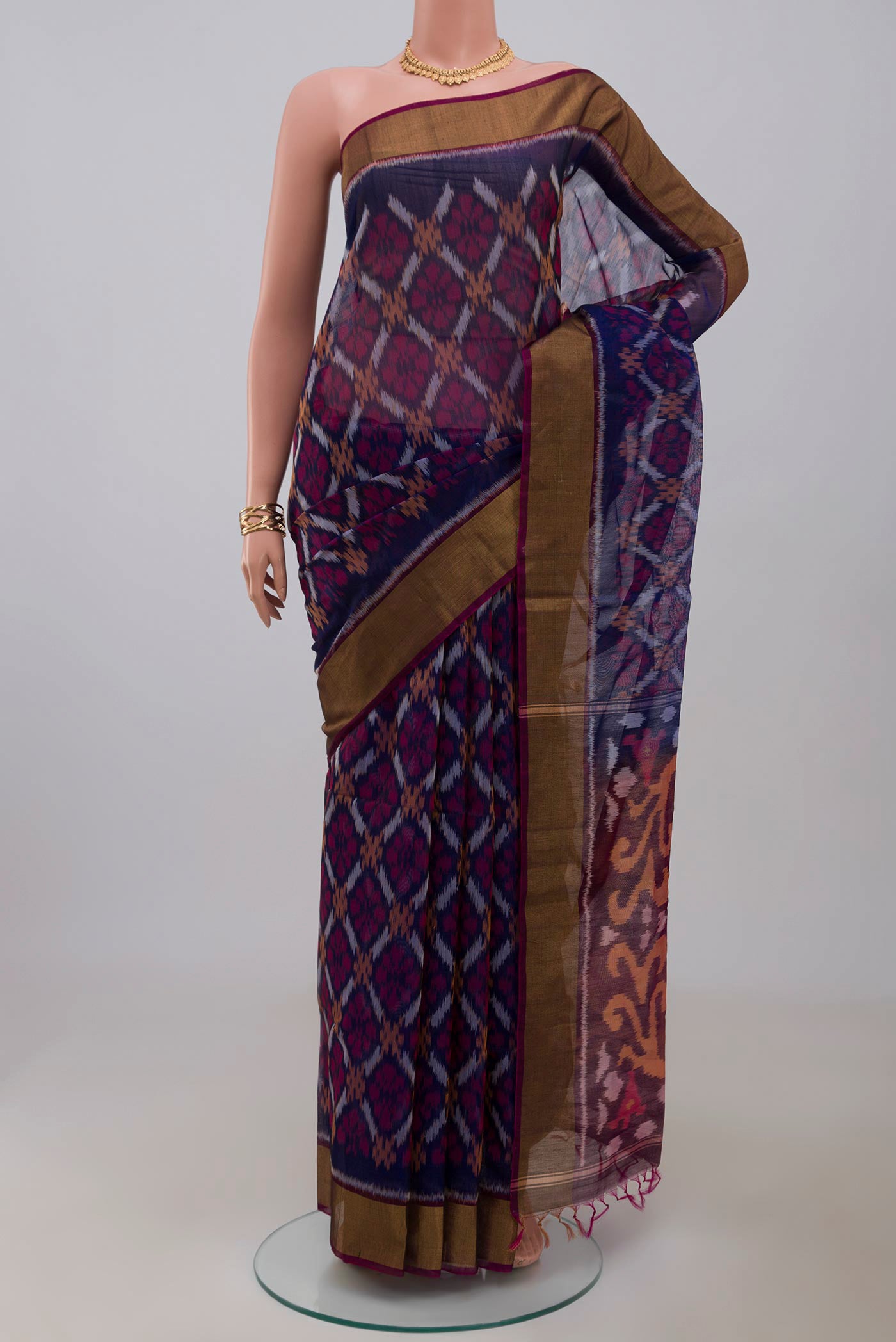 Blue Silk Cotton Saree with Ikat Print on the body and Zari Border.  displayed on a mannequin