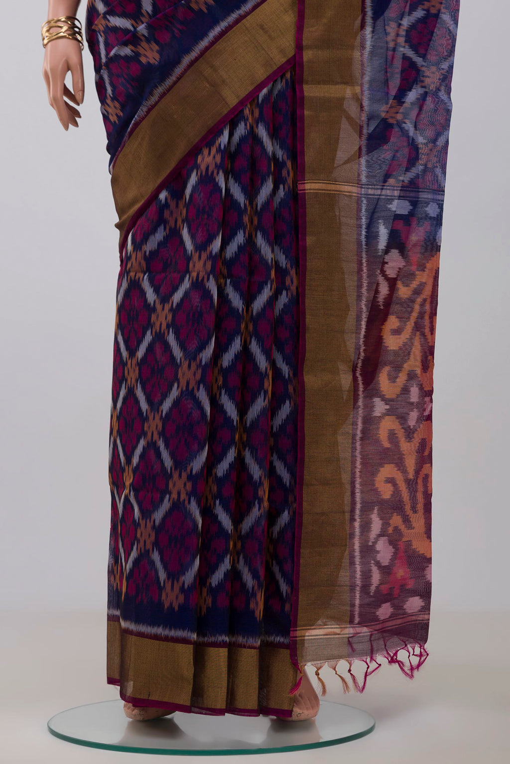 Pleats and pallu of Blue Silk Cotton Saree with Ikat Print on the body and Zari Border. 