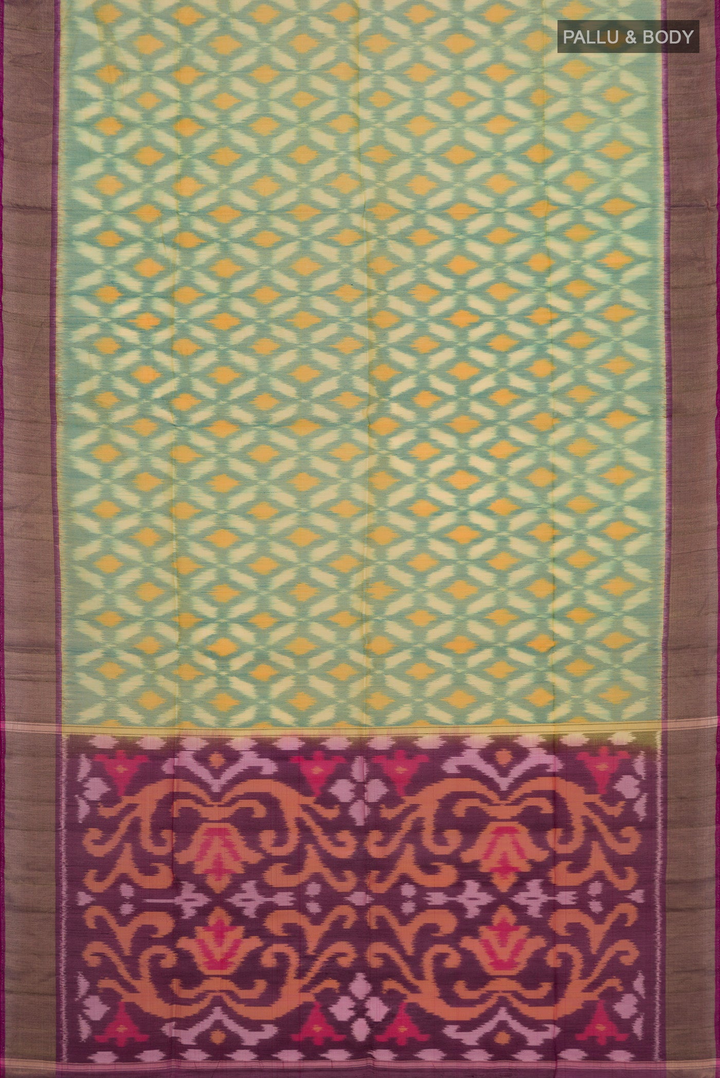 Flat view of Green Silk Cotton Saree with Ikat design on the body and Zari Border. 