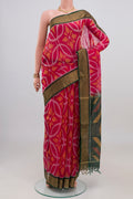 Pink Silk Cotton Saree with Ikat design on the body and Zari Border.  displayed on a mannequin