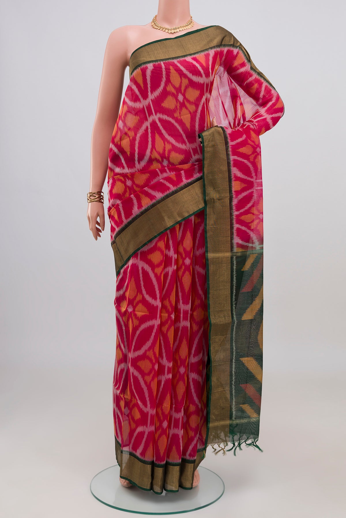 Pink Silk Cotton Saree with Ikat design on the body and Zari Border.  displayed on a mannequin
