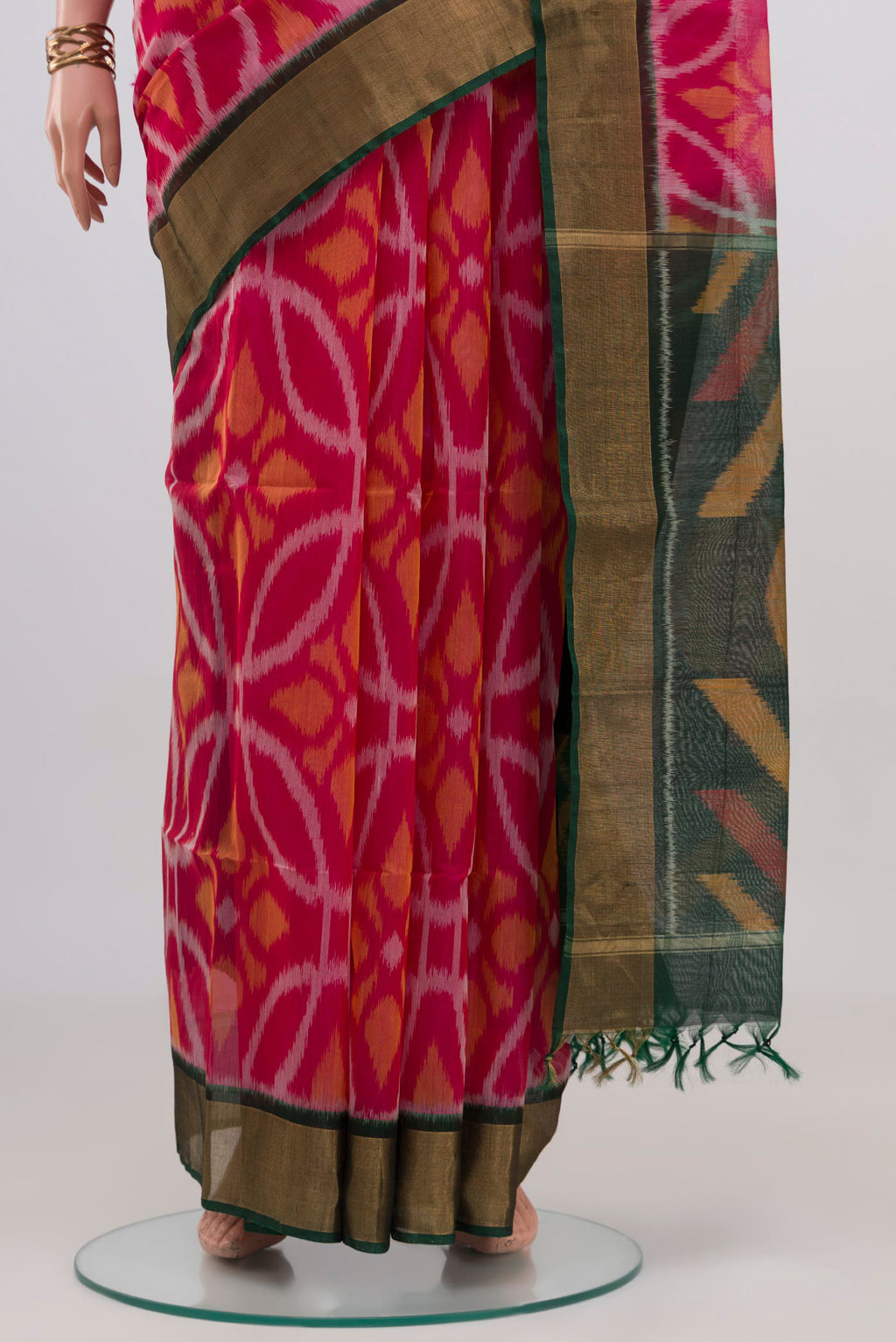 Pleats and pallu of Pink Silk Cotton Saree with Ikat design on the body and Zari Border. 