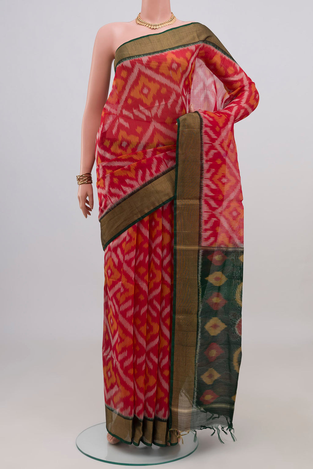 Red Silk Cotton Saree with Ikat design on the body and Zari Border.  displayed on a mannequin