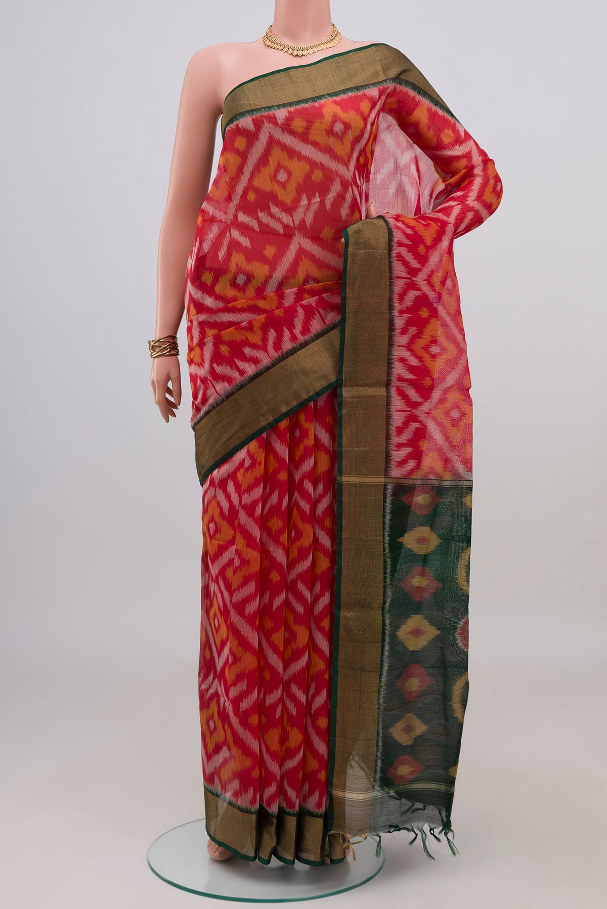 Red Silk Cotton Saree with Ikat design on the body and Zari Border.  displayed on a mannequin