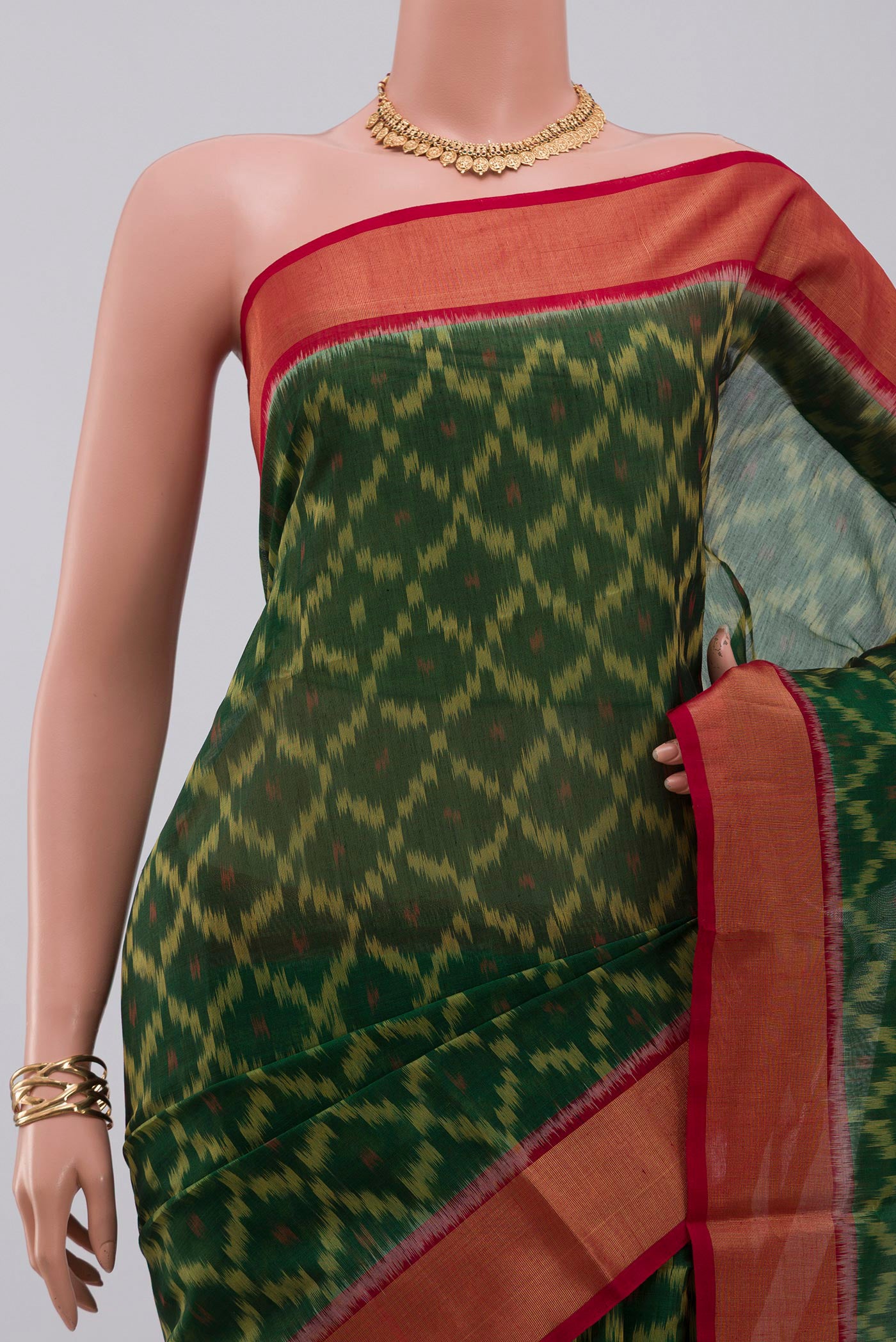 Border image of Green Silk Cotton Saree with Ikat Print on the body and Zari Border. 