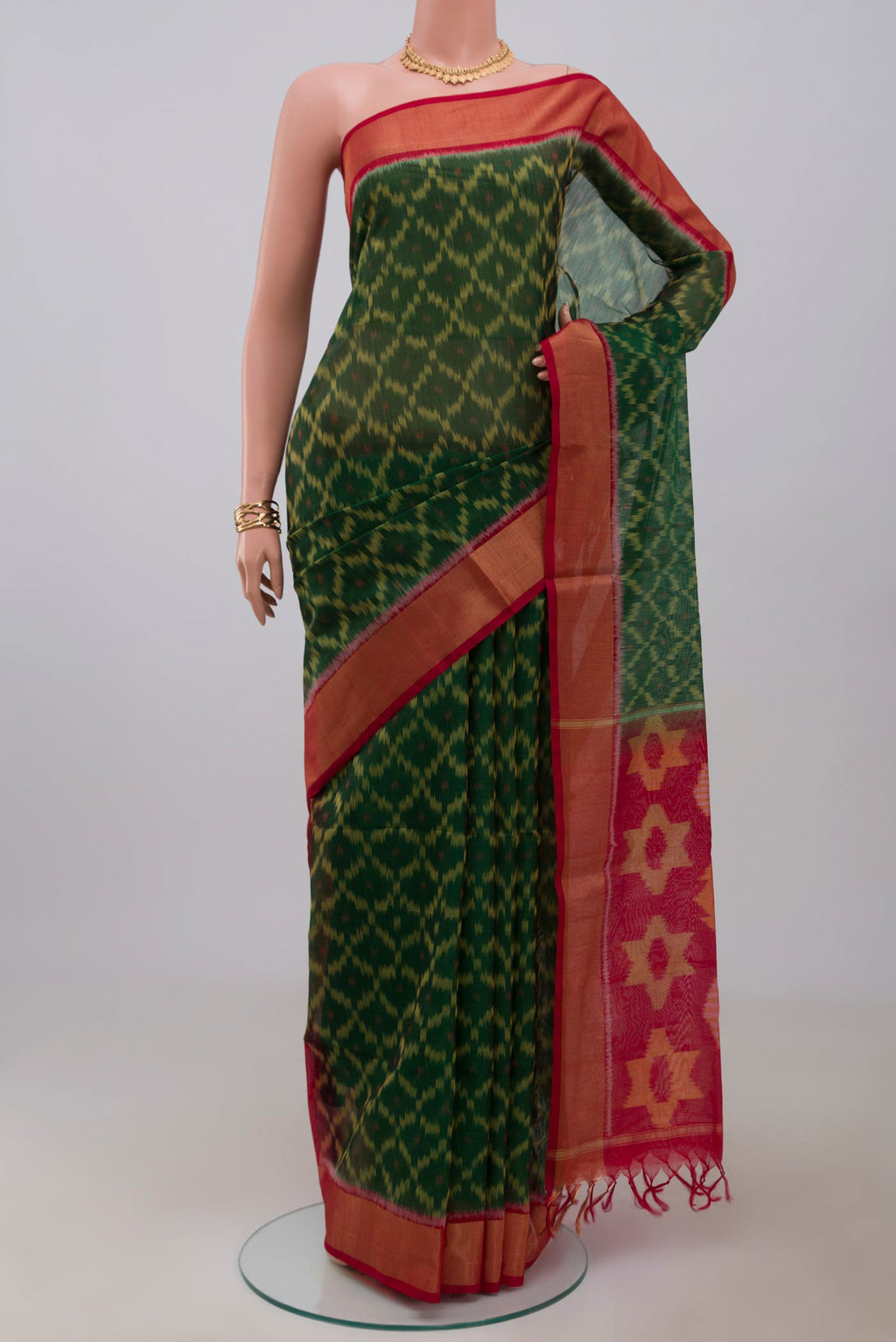 Green Silk Cotton Saree with Ikat Print on the body and Zari Border.  displayed on a mannequin