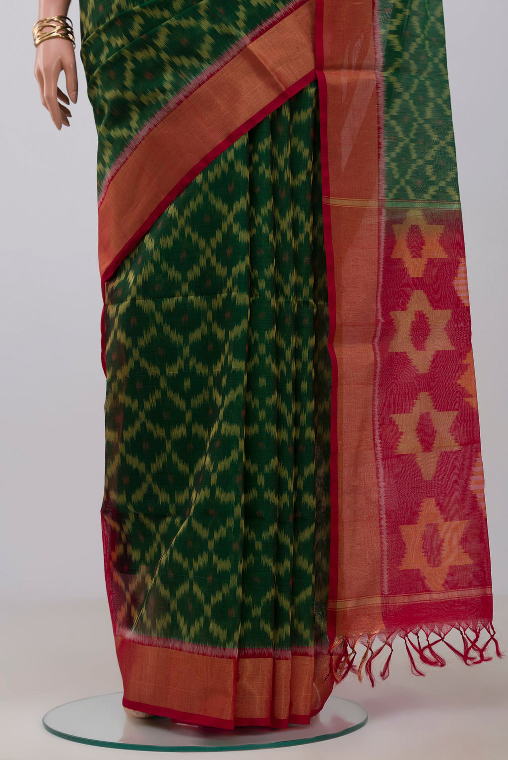 Pleats and pallu of Green Silk Cotton Saree with Ikat Print on the body and Zari Border. 