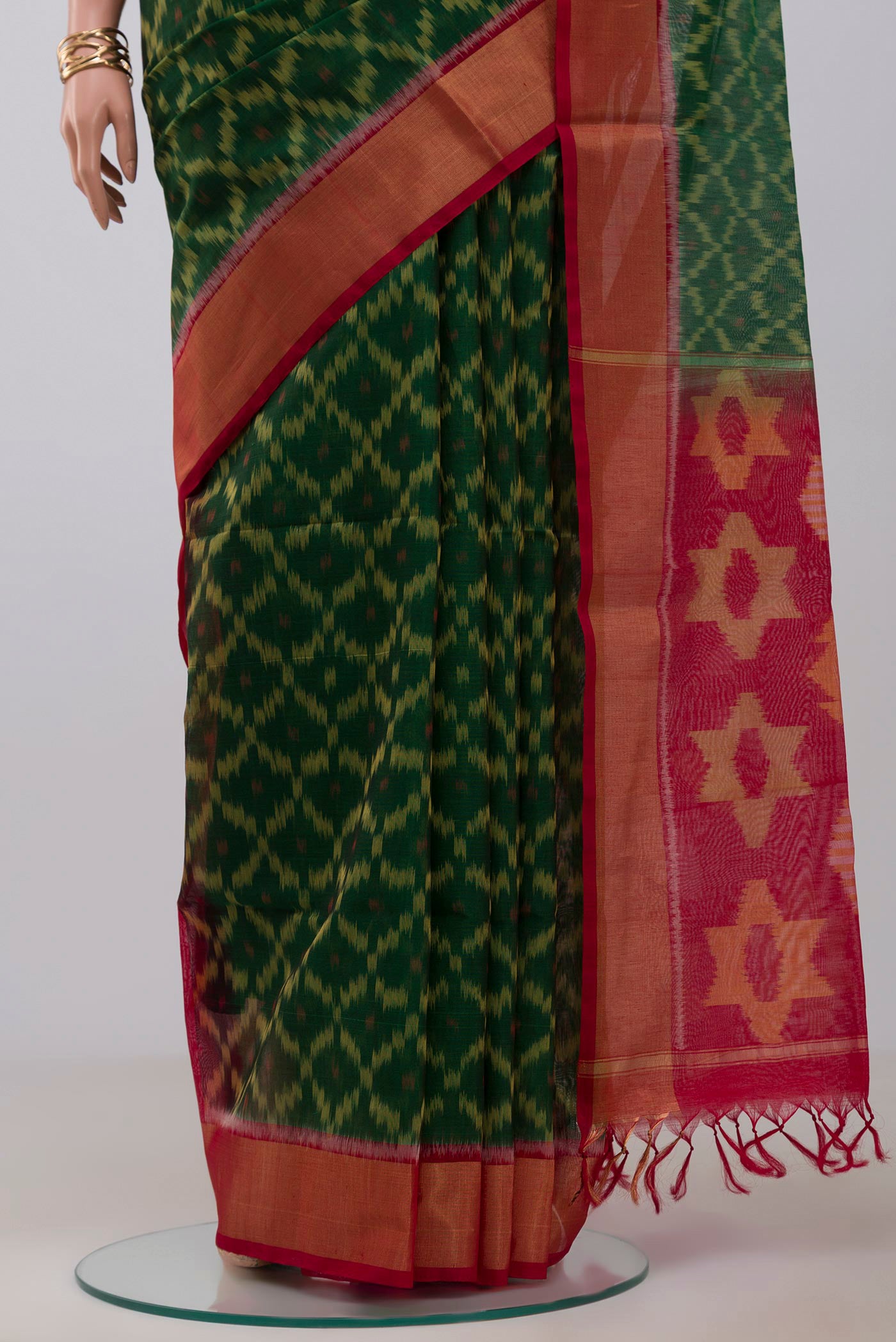 Pleats and pallu of Green Silk Cotton Saree with Ikat Print on the body and Zari Border. 