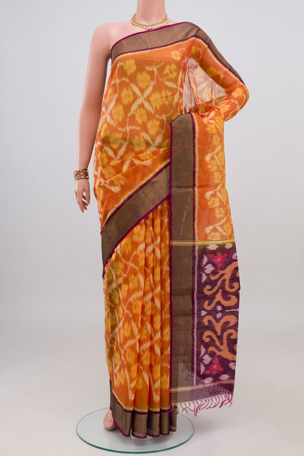 Yellow Silk Cotton Saree with Ikat design on the body and Zari Border.  displayed on a mannequin