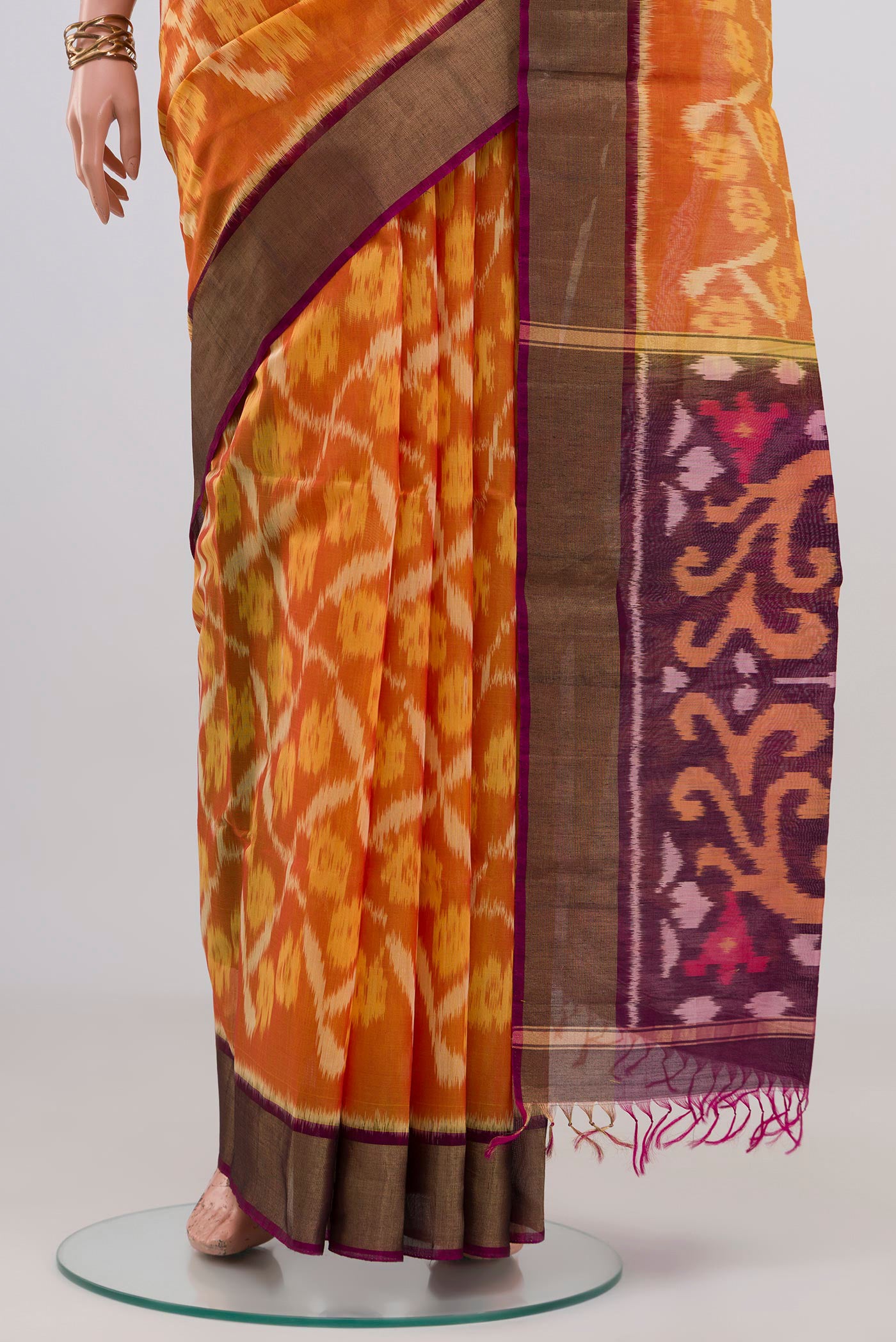 Pleats and pallu of Yellow Silk Cotton Saree with Ikat design on the body and Zari Border. 