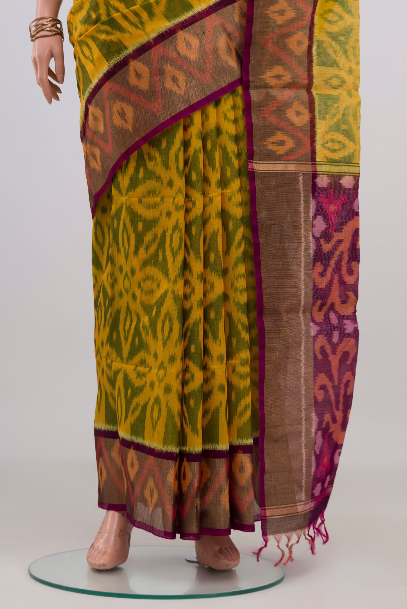 Pleats and pallu of Yellow Silk Cotton Saree with Ikat design on the body and Zari Border. 