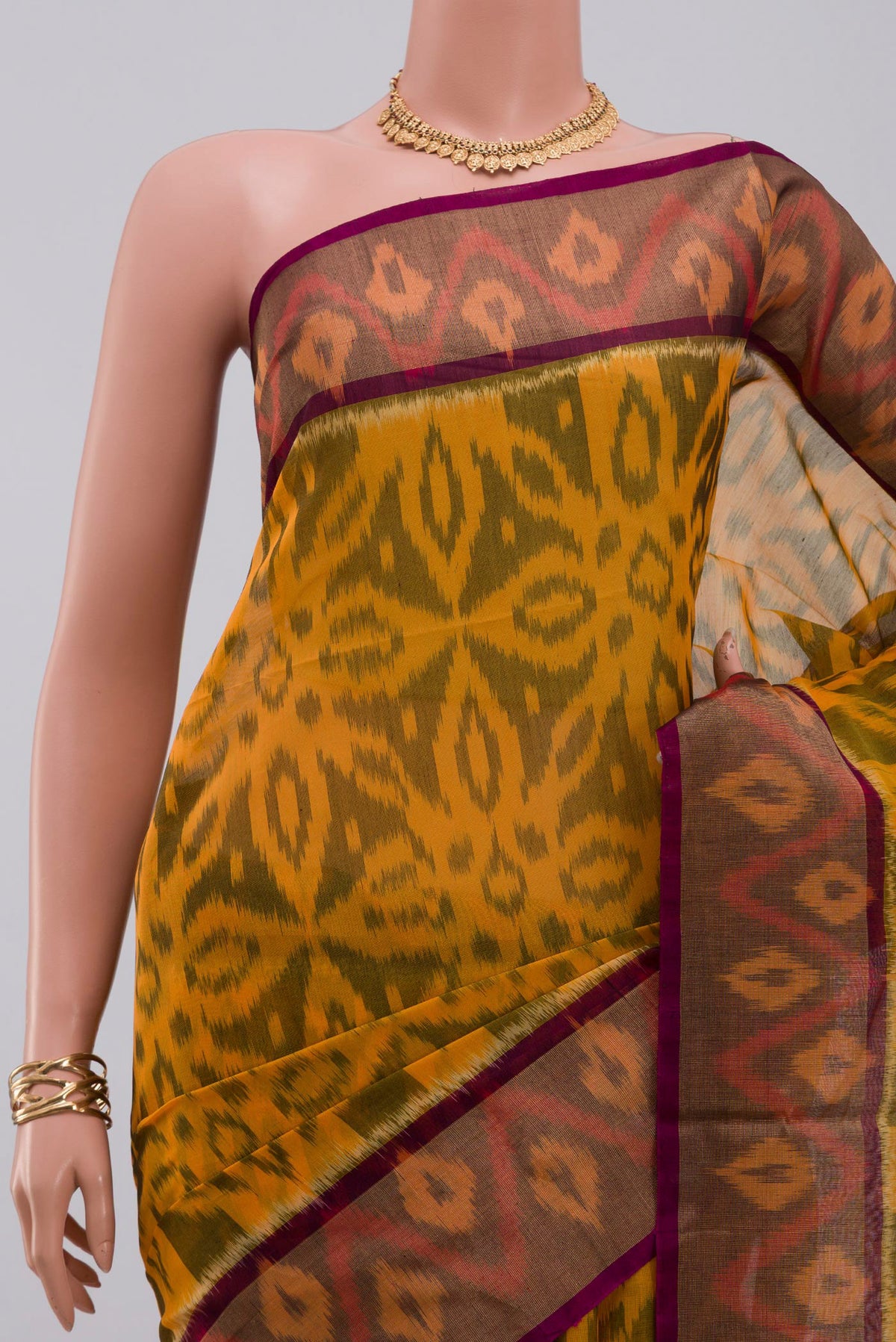 Border image of Yellow Silk Cotton Saree with Ikat Print on the body and Zari Border. 