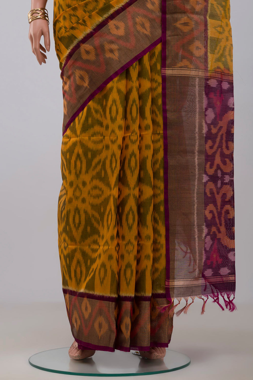 Pleats and pallu of Yellow Silk Cotton Saree with Ikat Print on the body and Zari Border. 