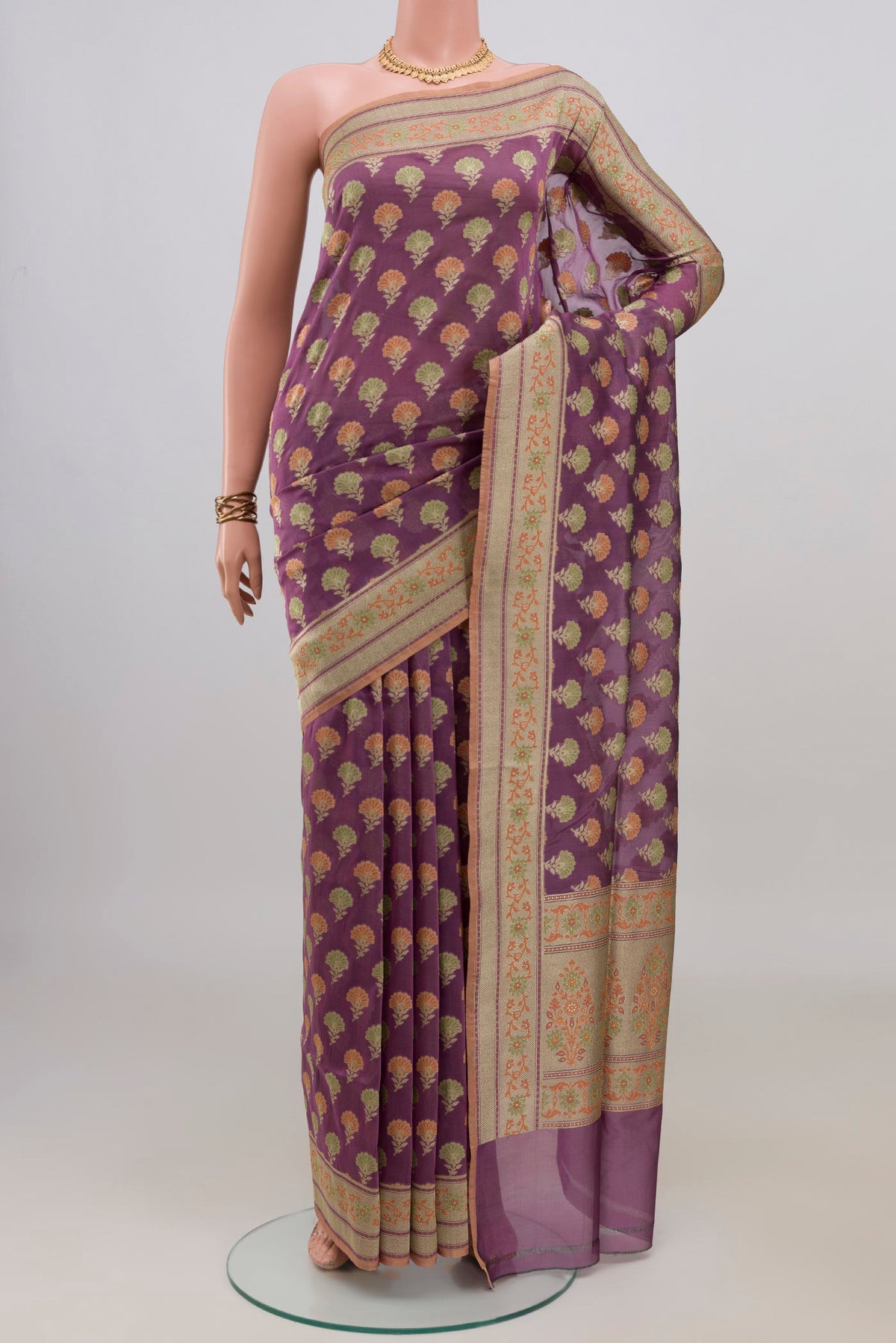 Pure Silk Mauve Banarasi Saree with Thread Butta on the body and Zari Border.  displayed on a mannequin