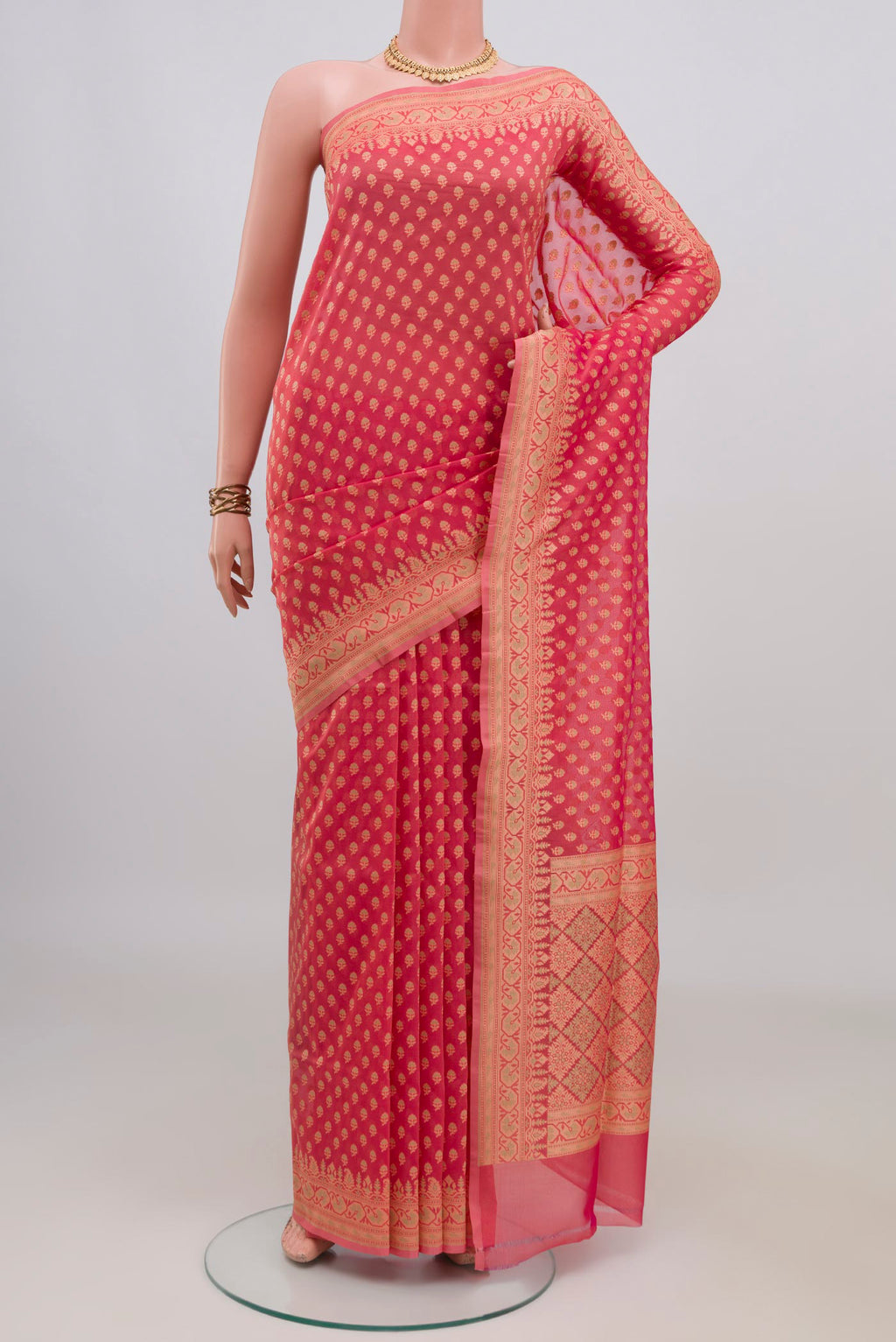 Pure Silk Coral Banarasi Saree with Zari And Thread Butta on the body and Zari Border.  displayed on a mannequin