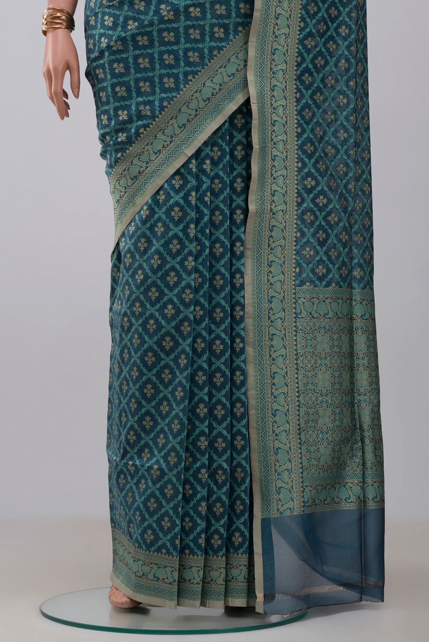 Pleats and pallu of Blue Grey Banarasi Silk Saree with Zari And Thread Butta on the body and Zari Border. 