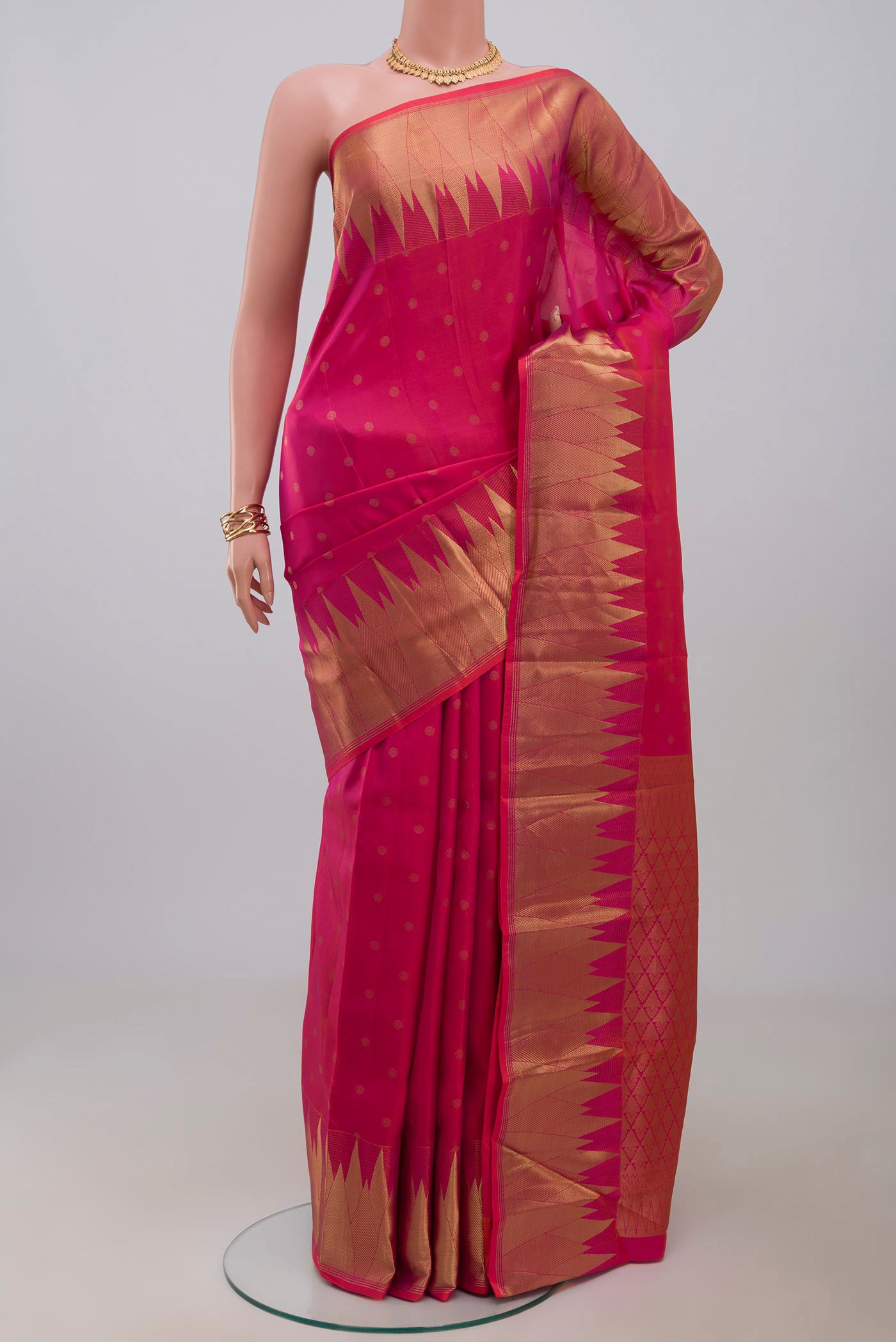 Pink Kanchipuram Silk Saree with Zari Butta on the body and Temple Border.  displayed on a mannequin