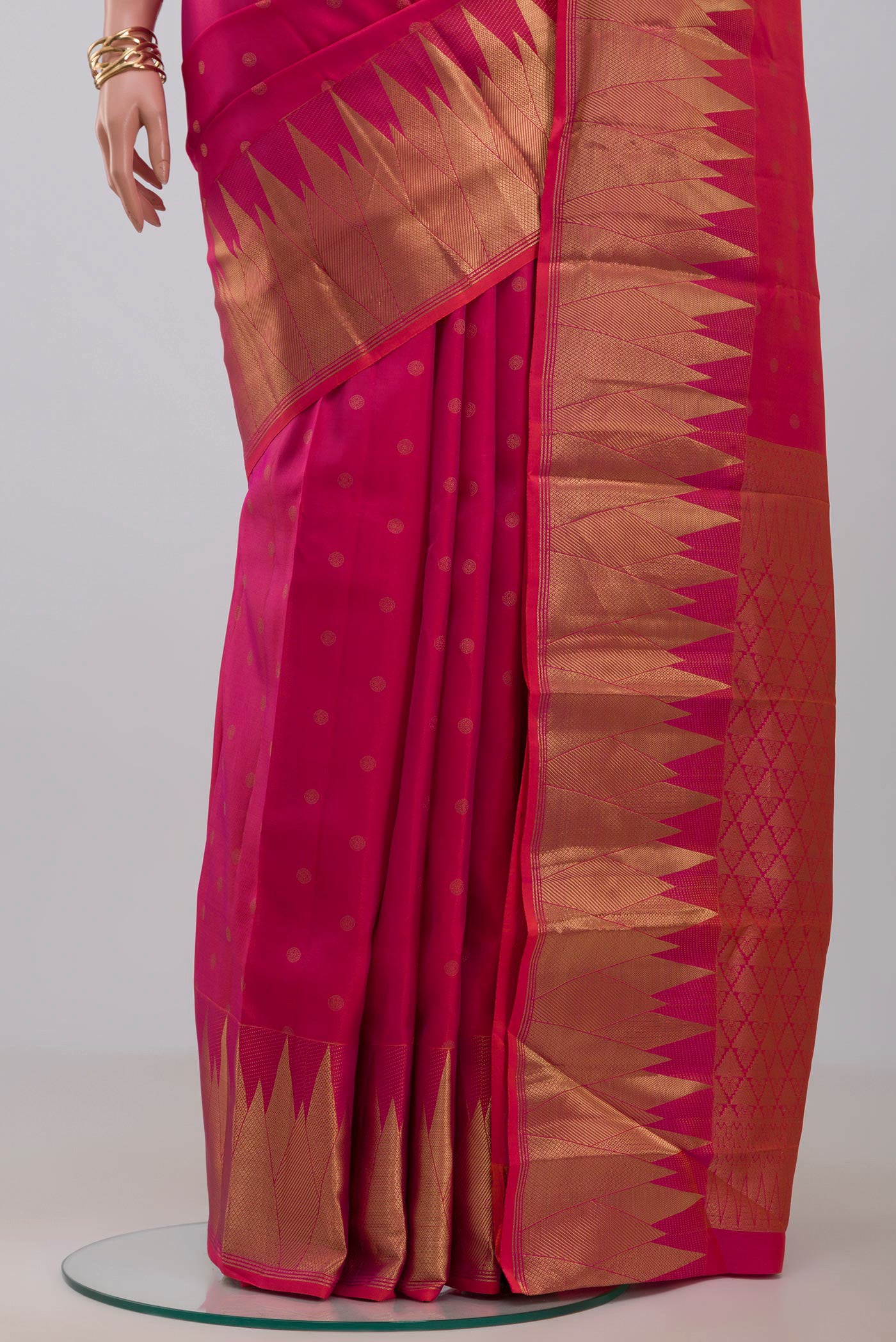 Pleats and pallu of Pink Kanchipuram Silk Saree with Zari Butta on the body and Temple Border. 