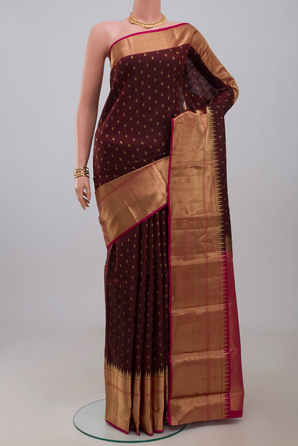 Brown Kanchipuram Silk Saree with Zari Butta on the body and Zari Border.  displayed on a mannequin