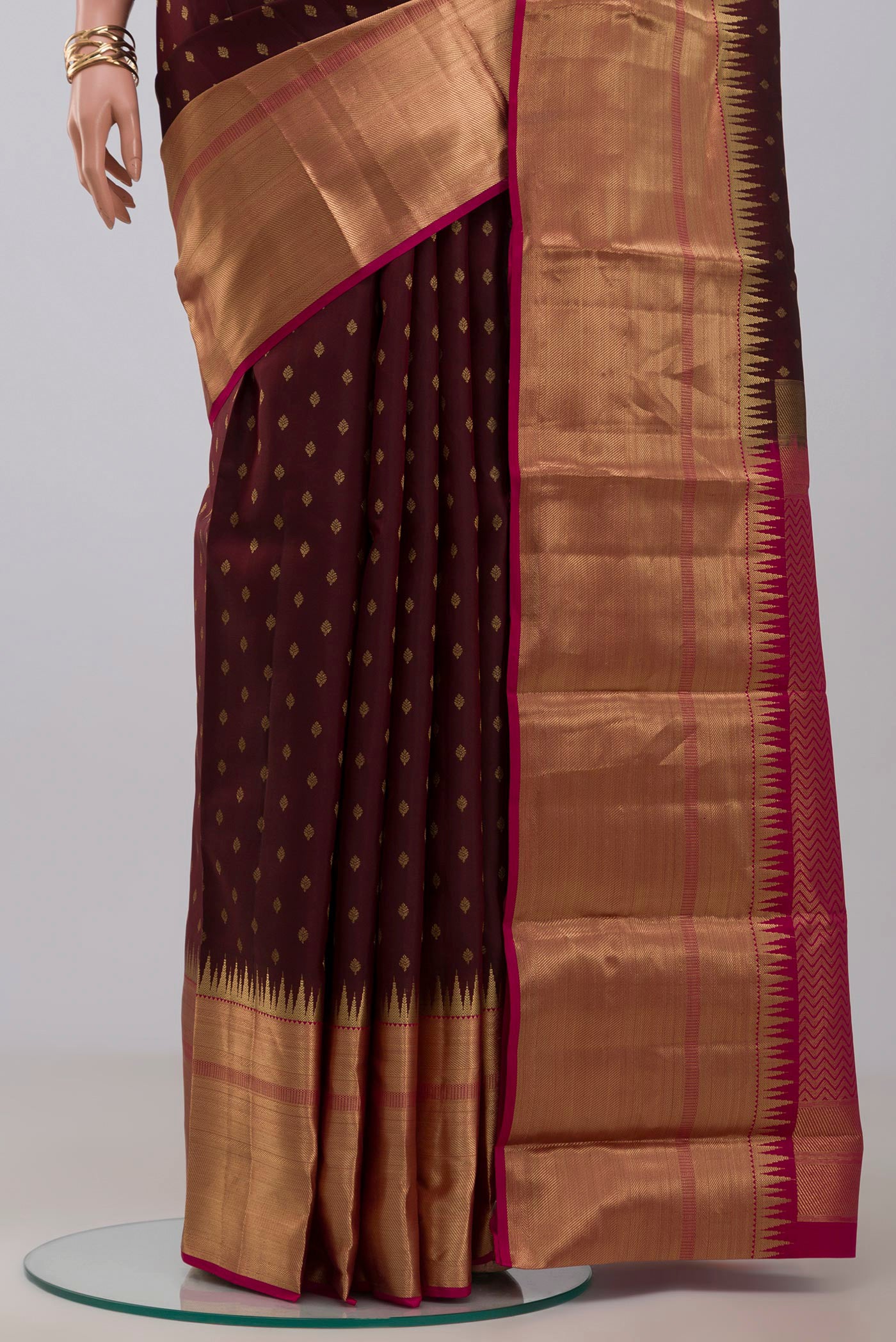 Pleats and pallu of Brown Kanchipuram Silk Saree with Zari Butta on the body and Zari Border. 