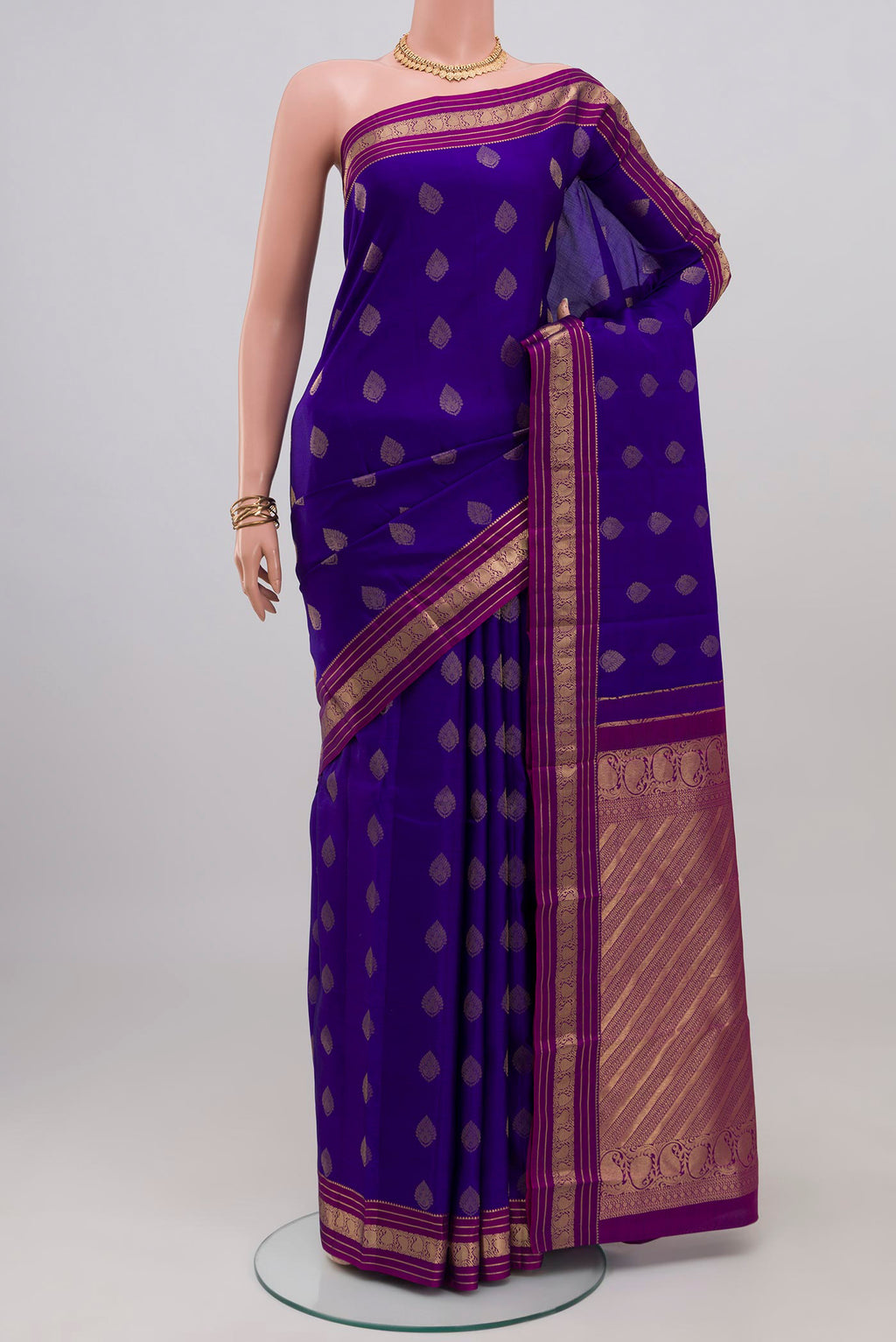 Blue Kanchipuram Silk Saree with Zari Butta on the body and Zari Border.  displayed on a mannequin