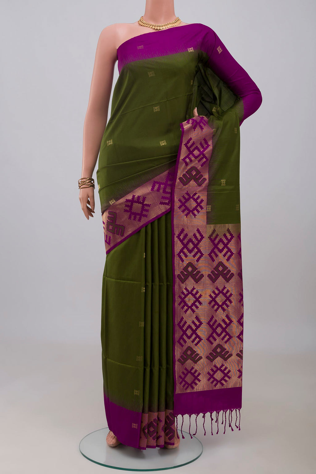 Green Soft Silk Saree with Zari Butta on the body and Fancy Border.  displayed on a mannequin