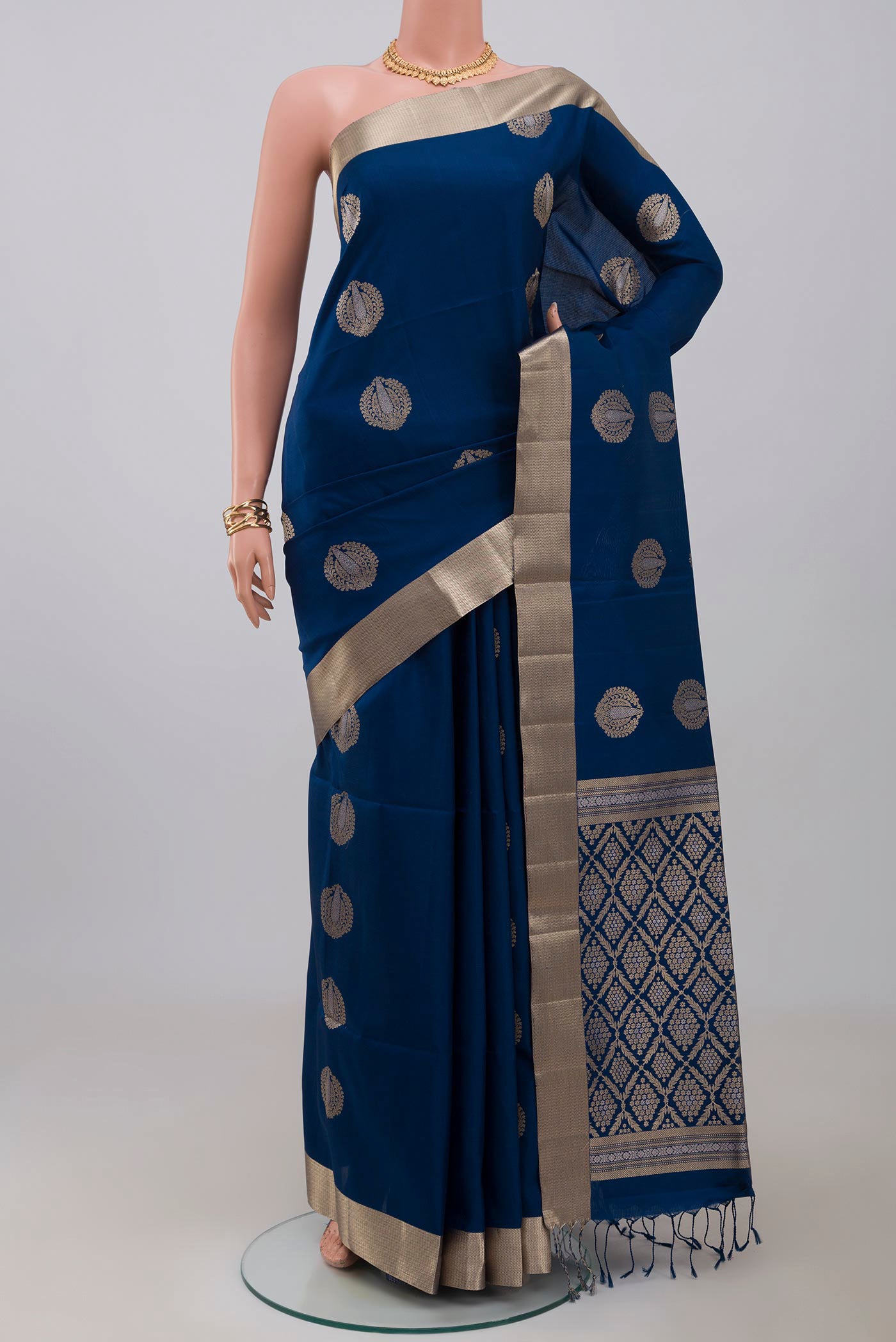 Blue Soft Silk Saree with Zari Butta on the body and Zari Border.  displayed on a mannequin