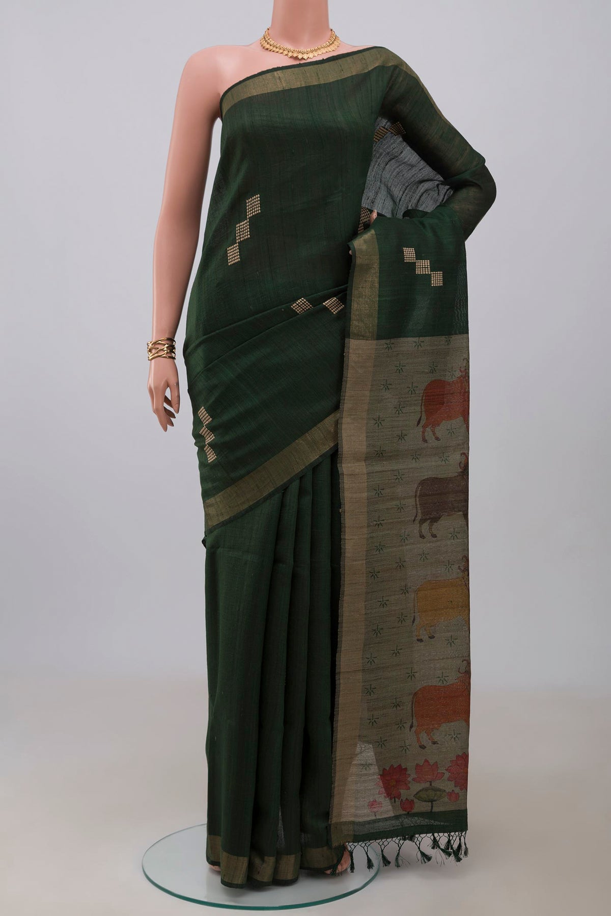 Green Tussar Silk Saree with Thread Butta on the body and Zari Border.  displayed on a mannequin